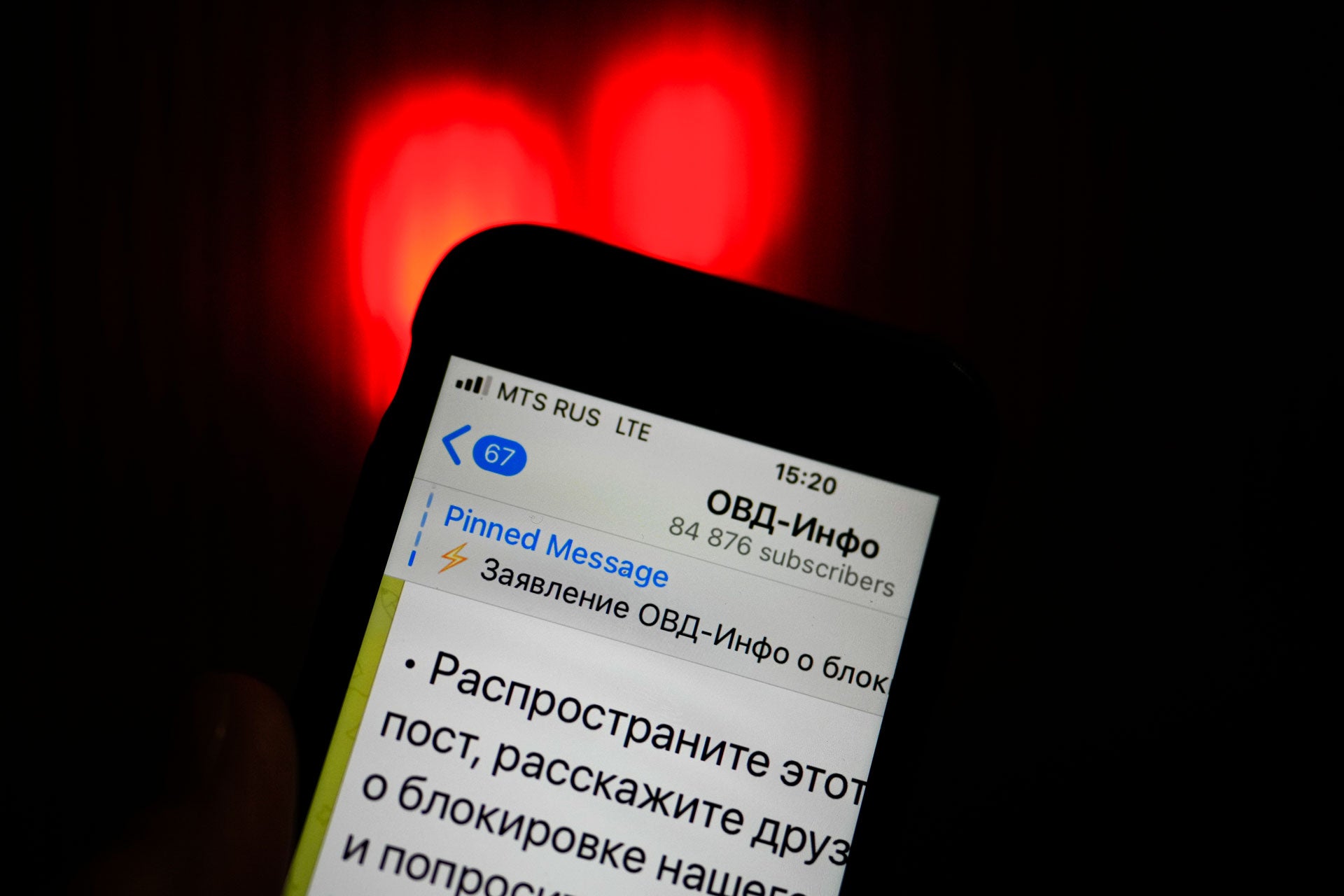 An iPhone screen shows the Telegram account of OVD-Info