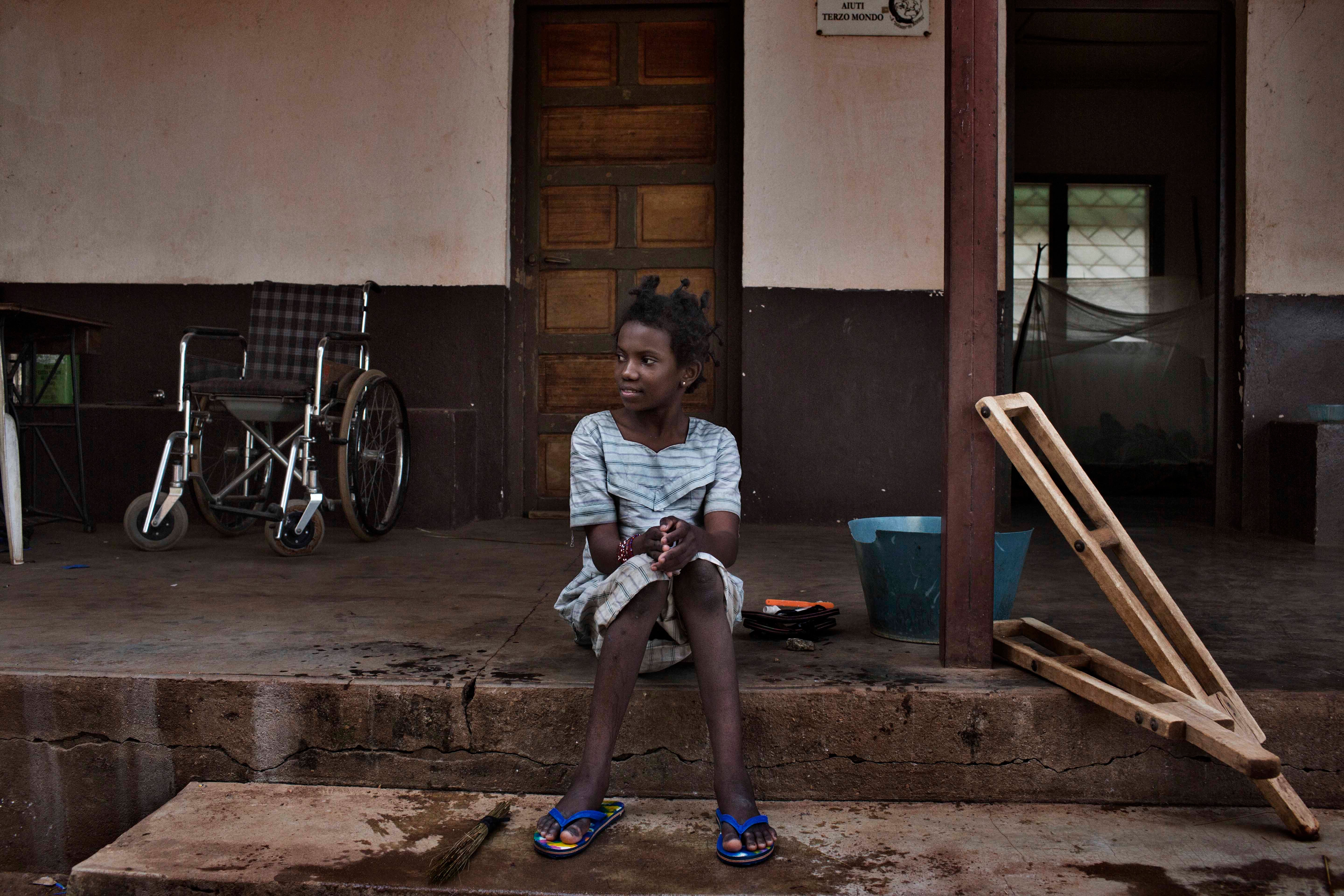 Hamamatou, a 13-year-old girl who had polio, in front of a Catholic mission where she lived in 2015.