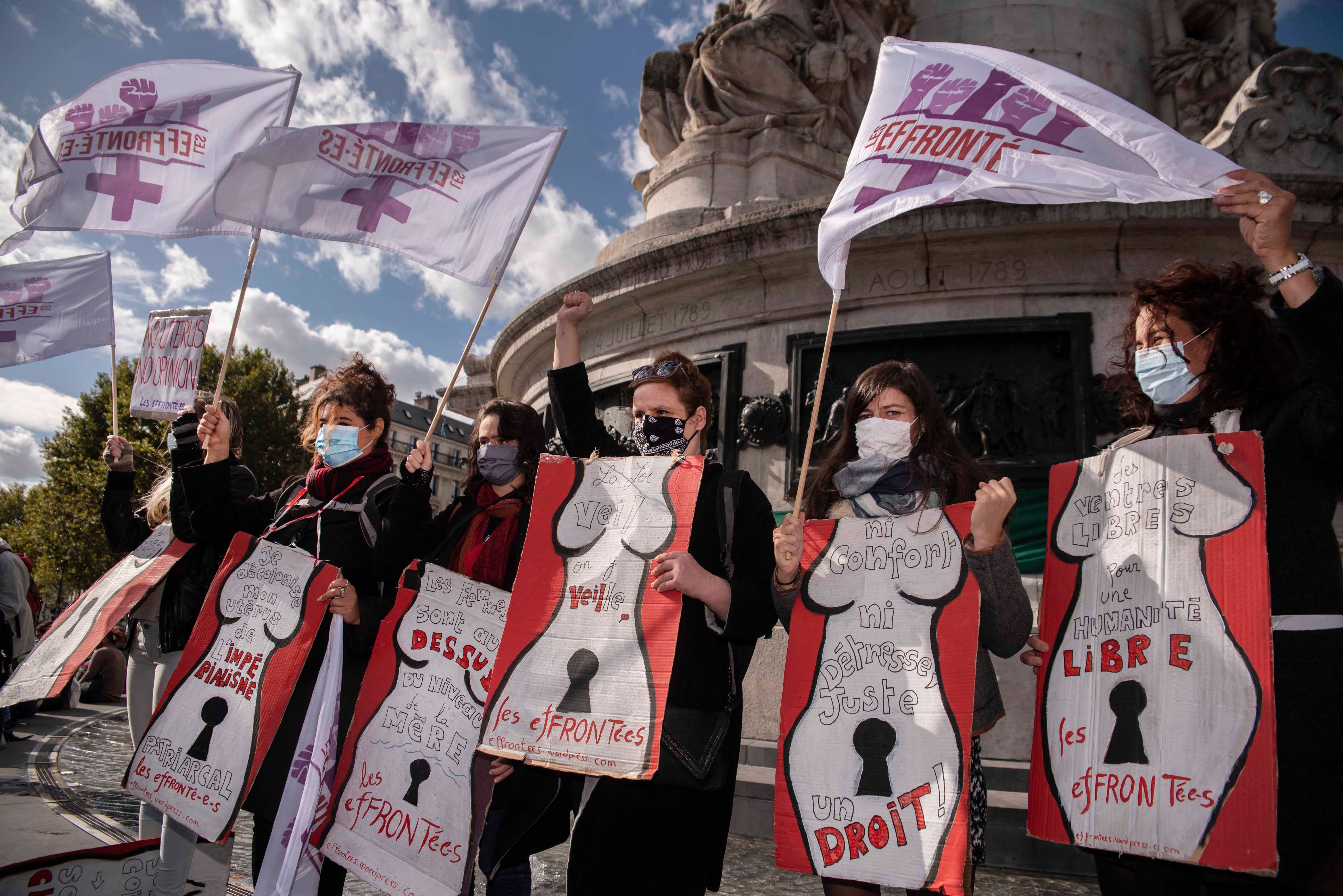 Women at a protest holding placards and flags