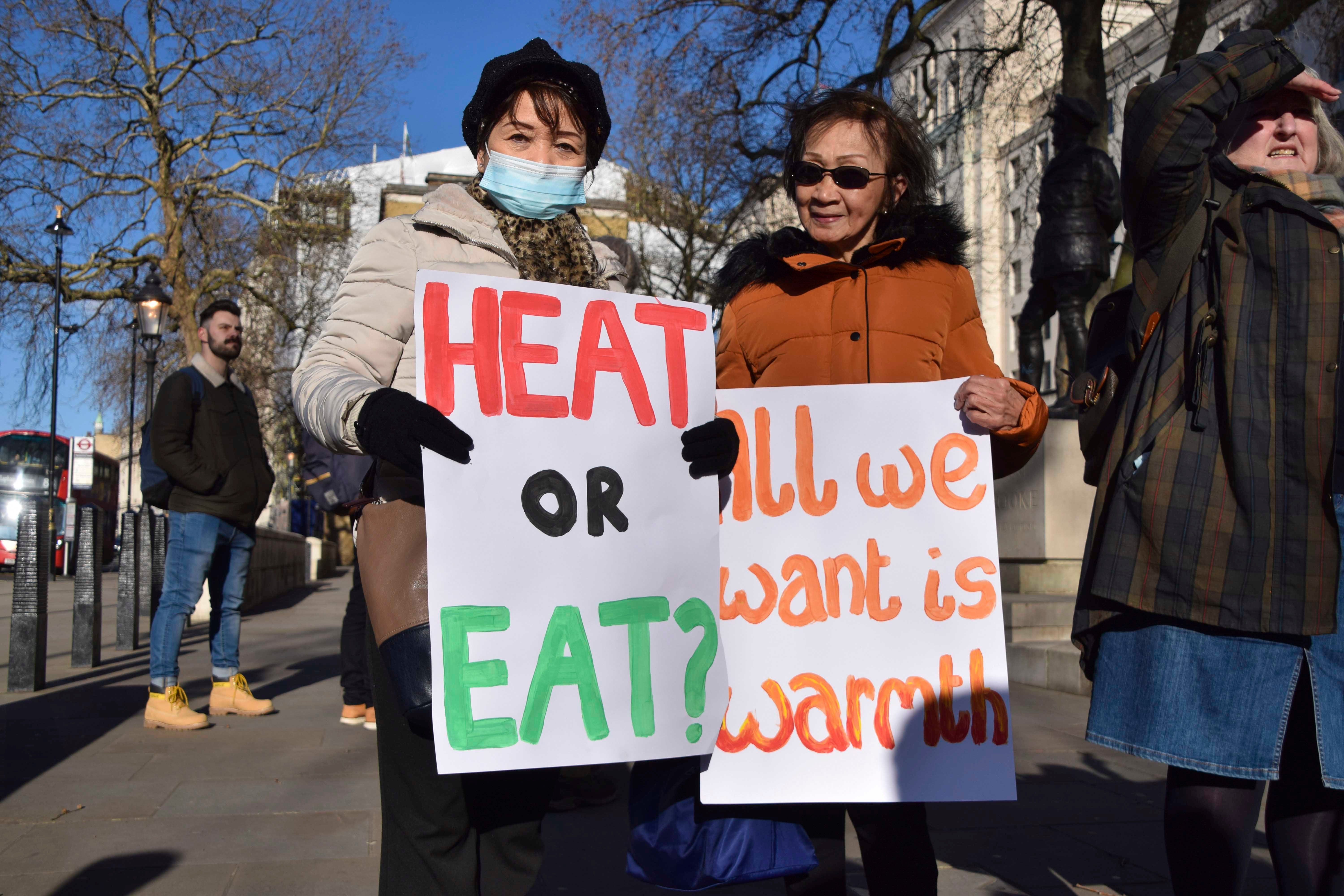 Protesters hold placards during a rally urging the government to help people with their energy bills, London, United Kingdom, January 31, 2022.