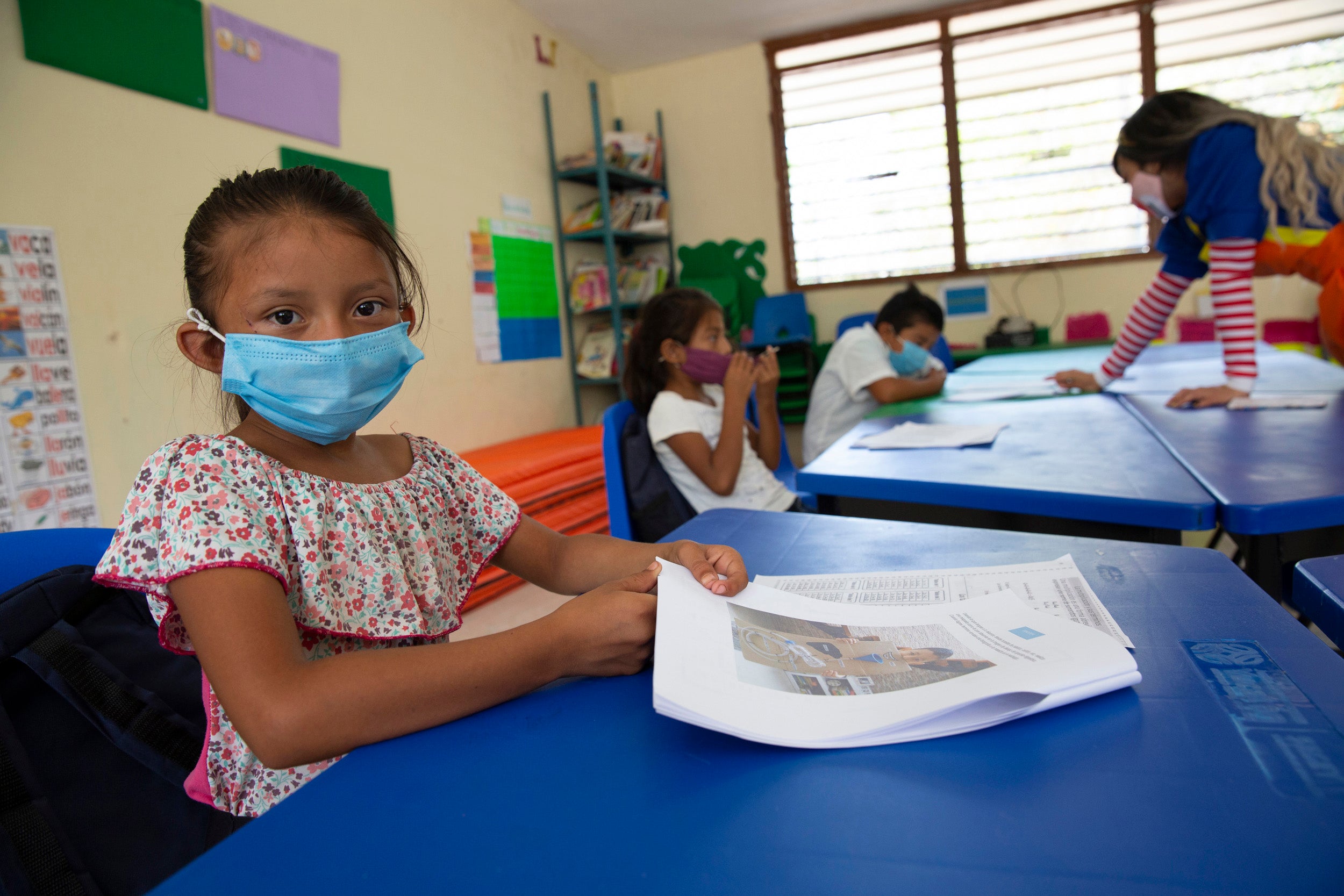 A child wears a face mask in a classroom