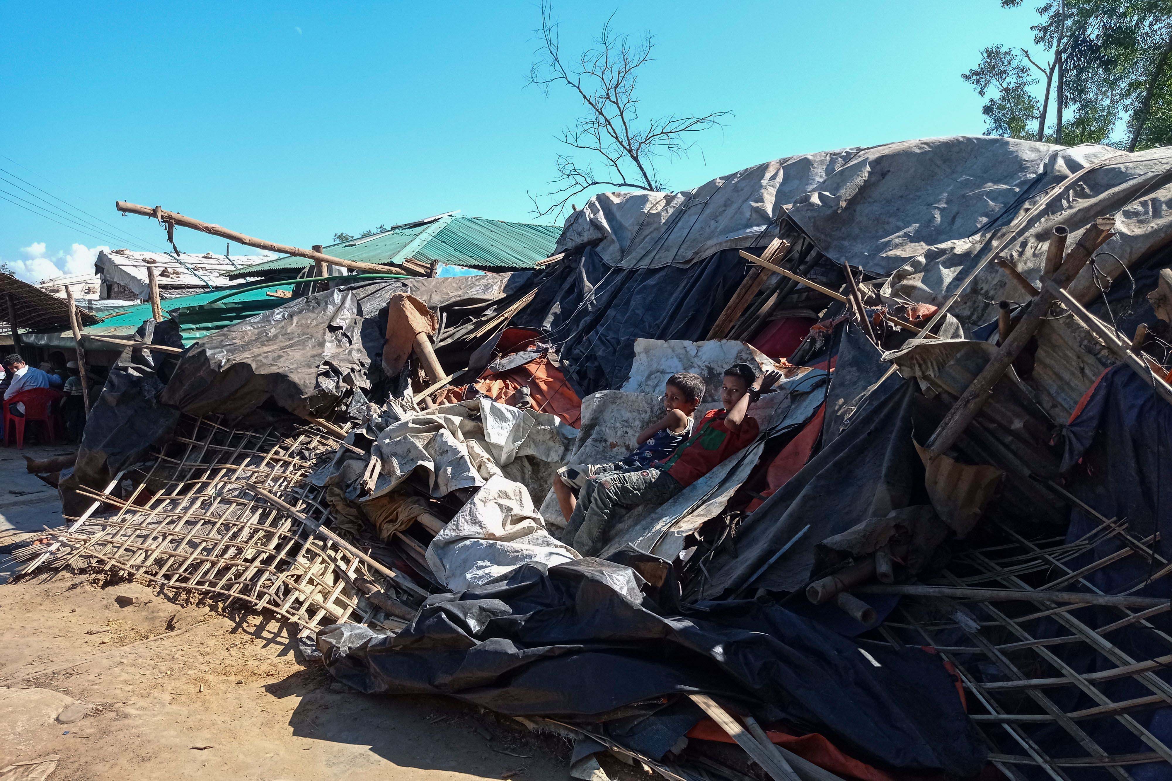 Rohingya refugees lie on a razed shop demolished by authorities in the Kutupalong camp in Ukhia, Bangladesh, December 10, 2021. 