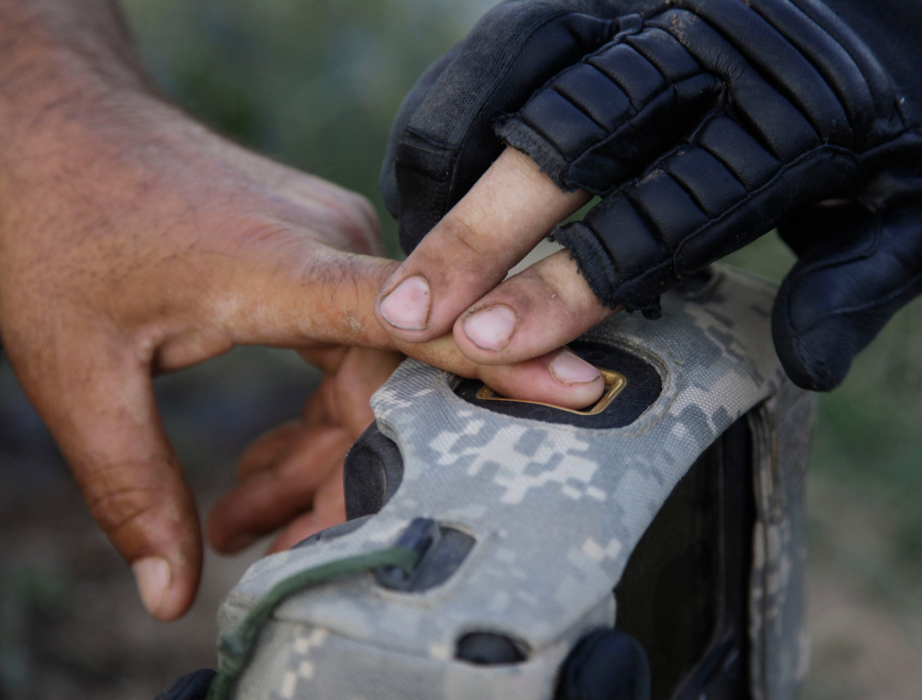 A United States military official takes the fingerprints of a man in Afghanistan