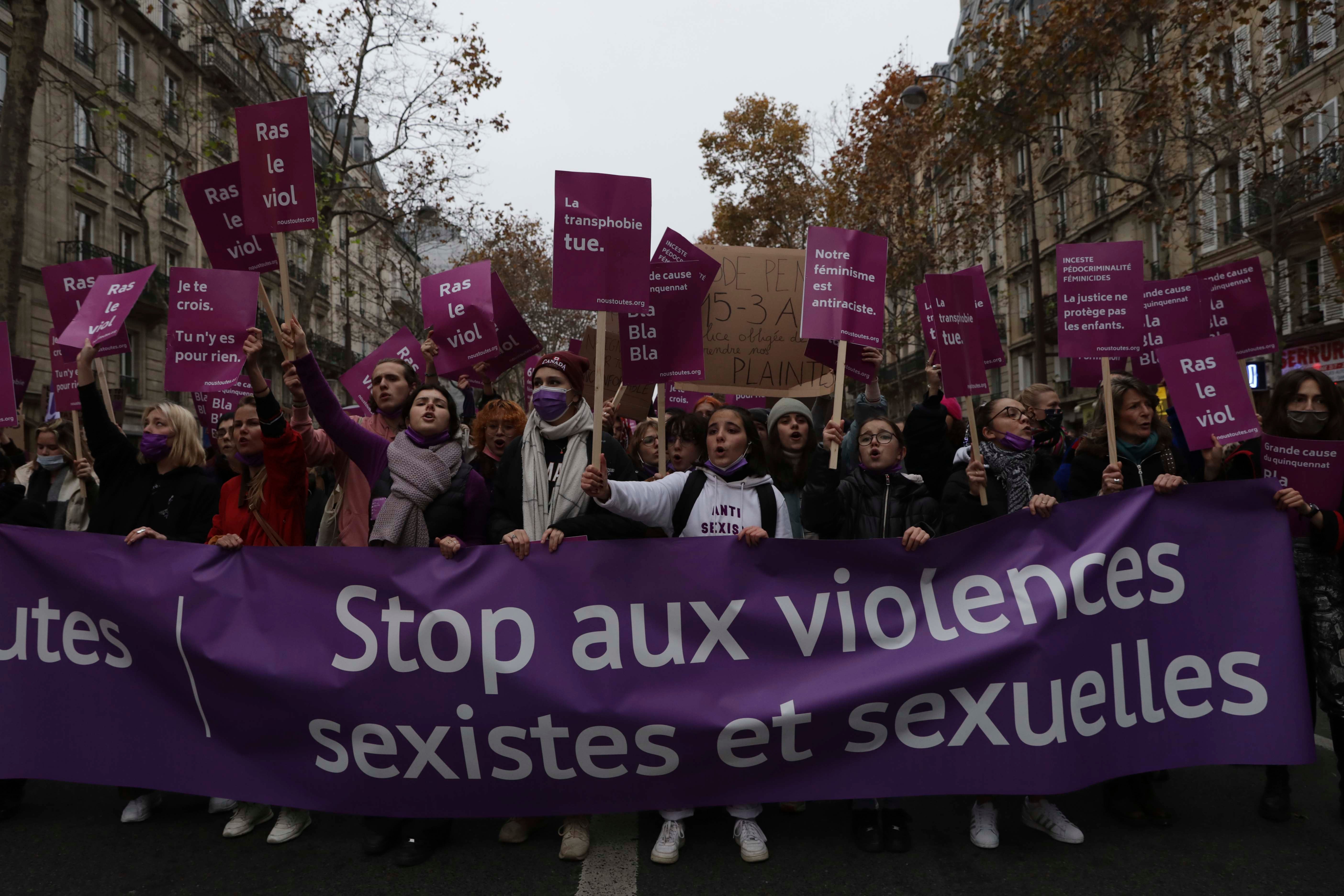 Women carry a banner reading "stop sexist and sexual violence " on November 20, 2021 in Paris.