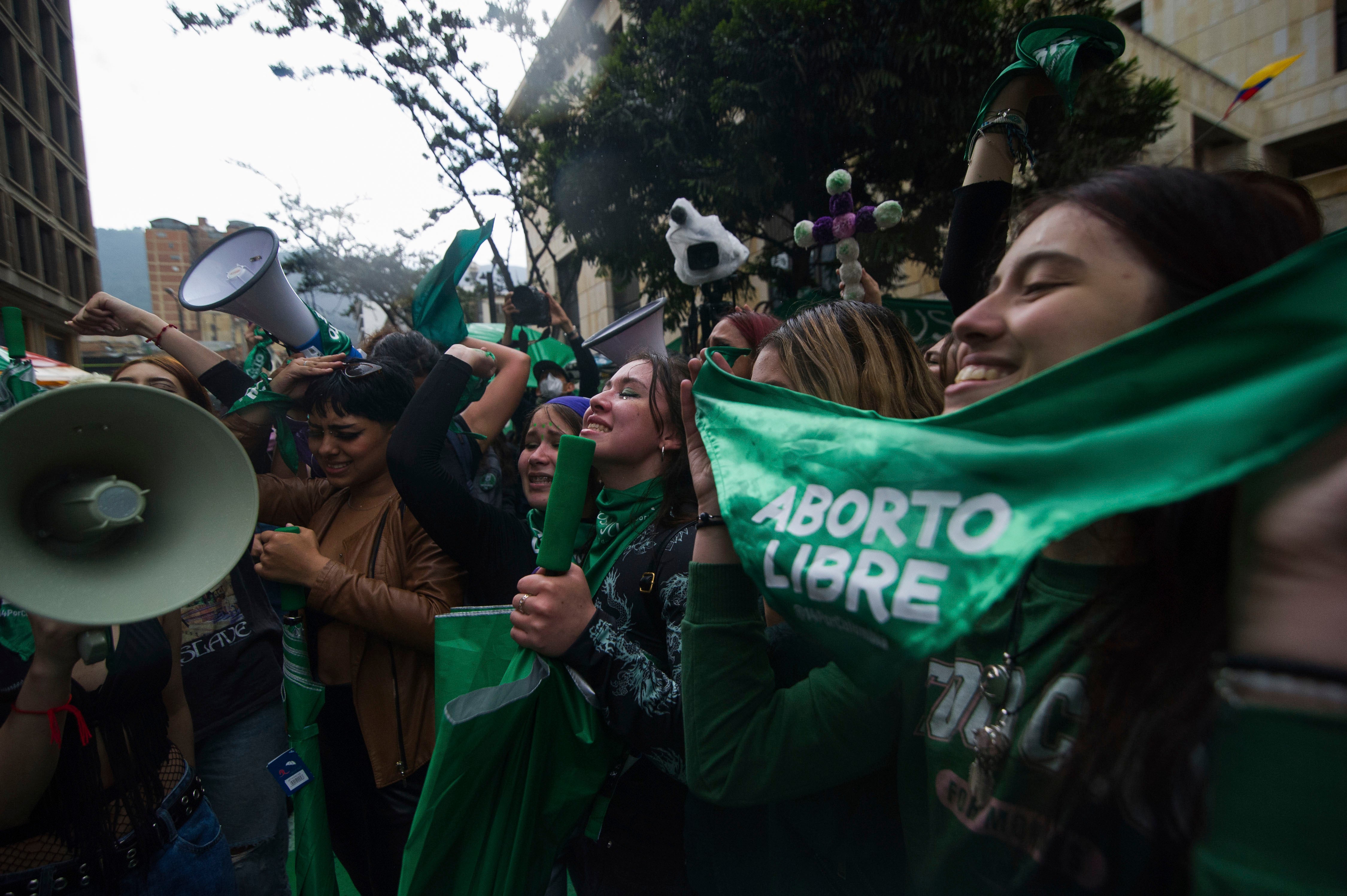 Activists holding green bandanas 