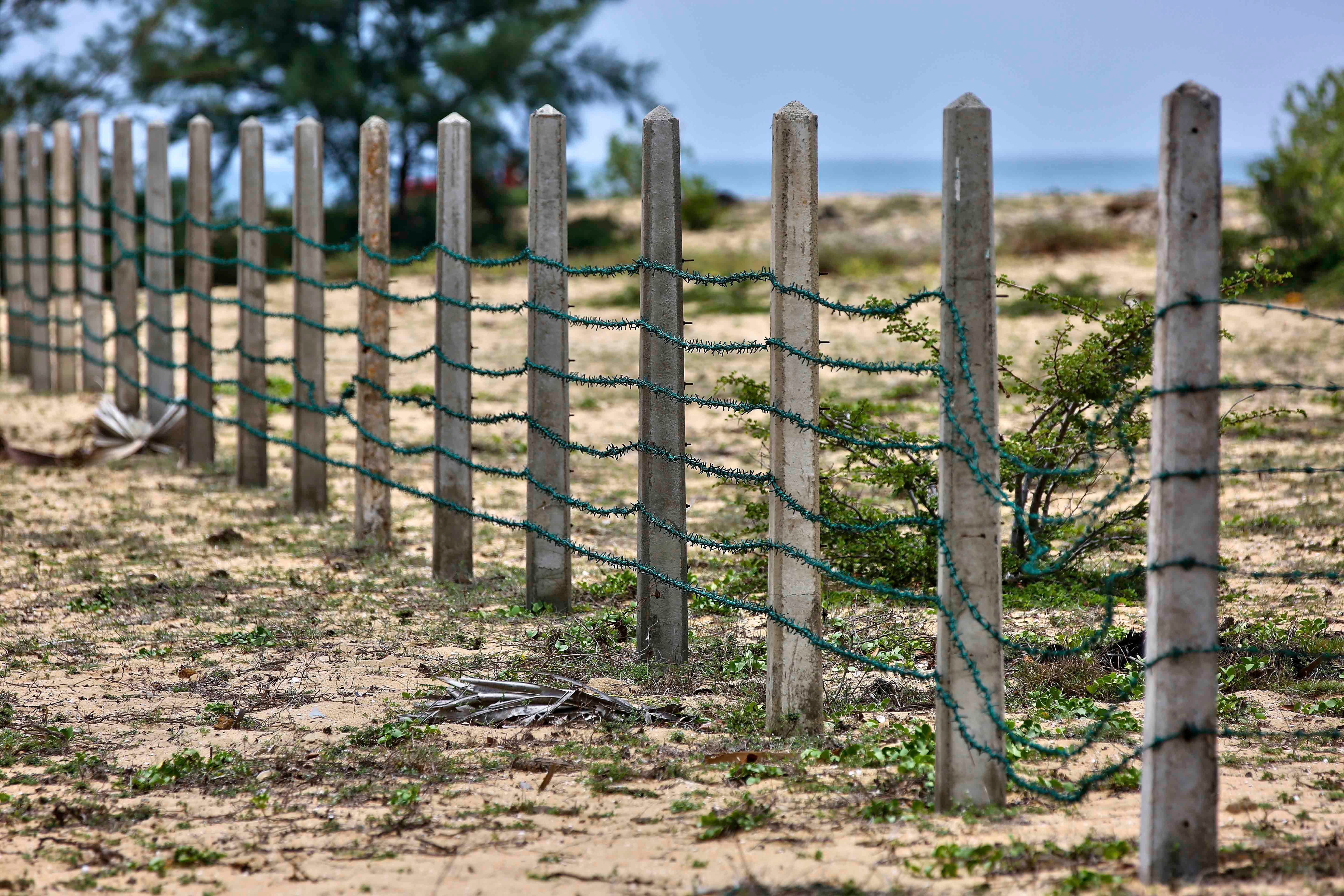 Razor wire fencing on a beach