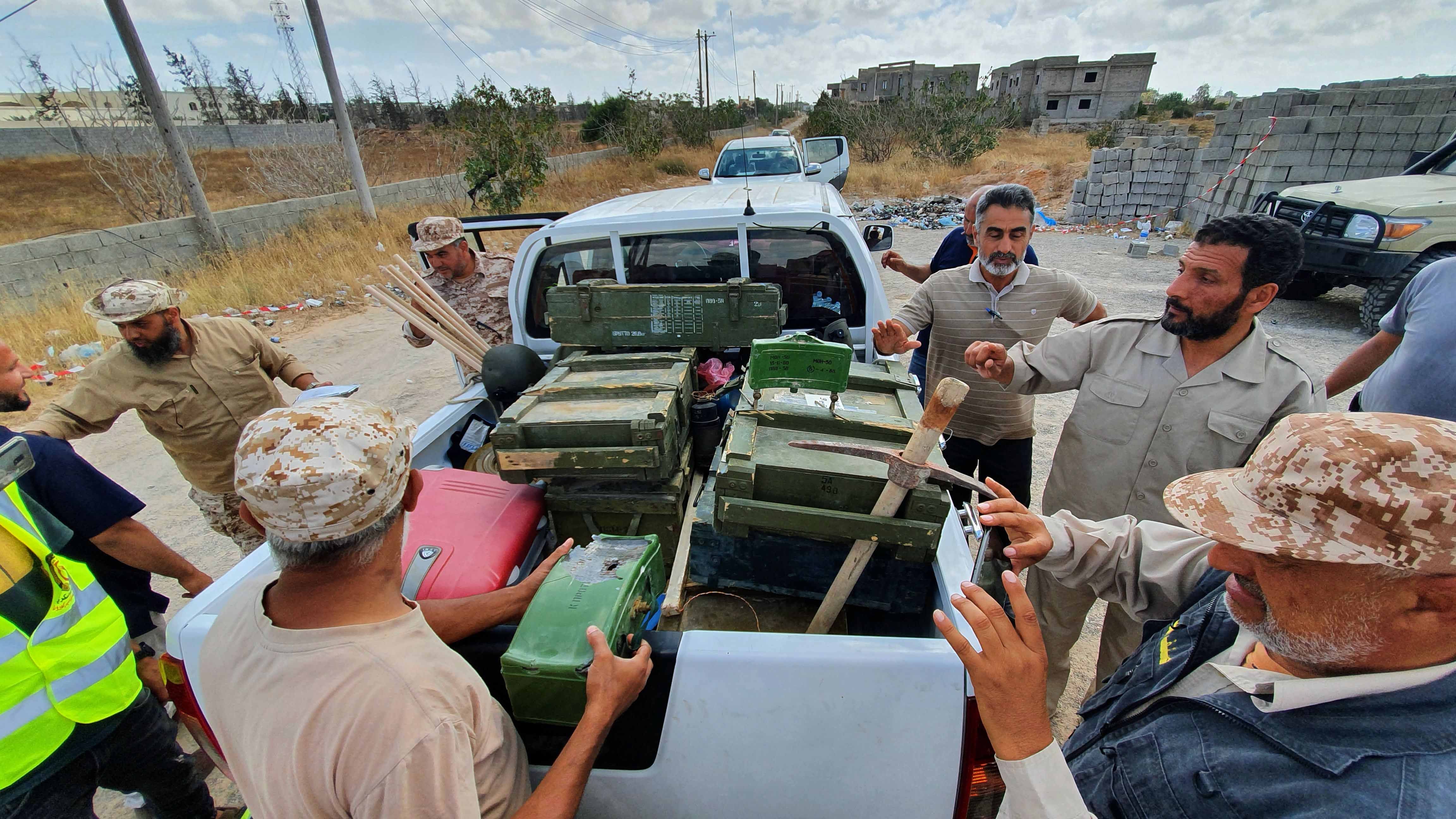 Libyan deminers stand around a pickup truck with boxes of dismantled mines and remnants of other explosives in Salah al-Din, south of the Libyan capital, Tripoli, June 15, 2020. ​​​​​​​