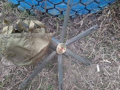 A POM-3 antipersonnel mine and its parachute that failed to deploy correctly and was found by deminers in the Kharkiv region, Ukraine, March 2022. 
