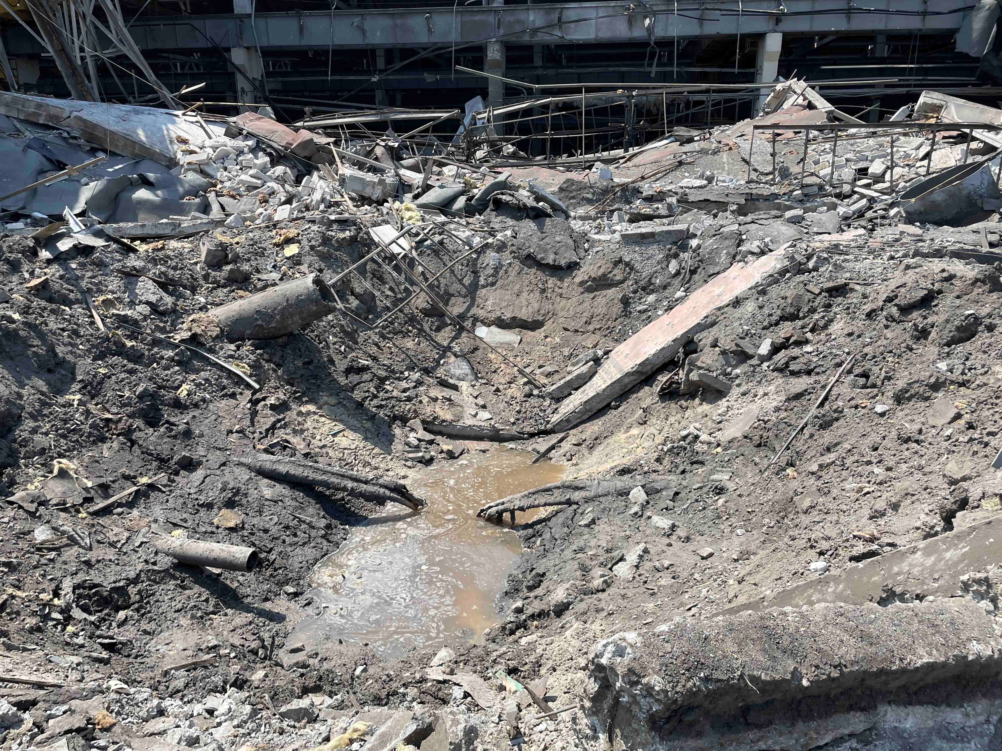 Impact crater at the Kremenchuk Road Vehicle Factory, a large industrial complex adjacent to the shopping center. Photo taken on June 29, 2022. 
