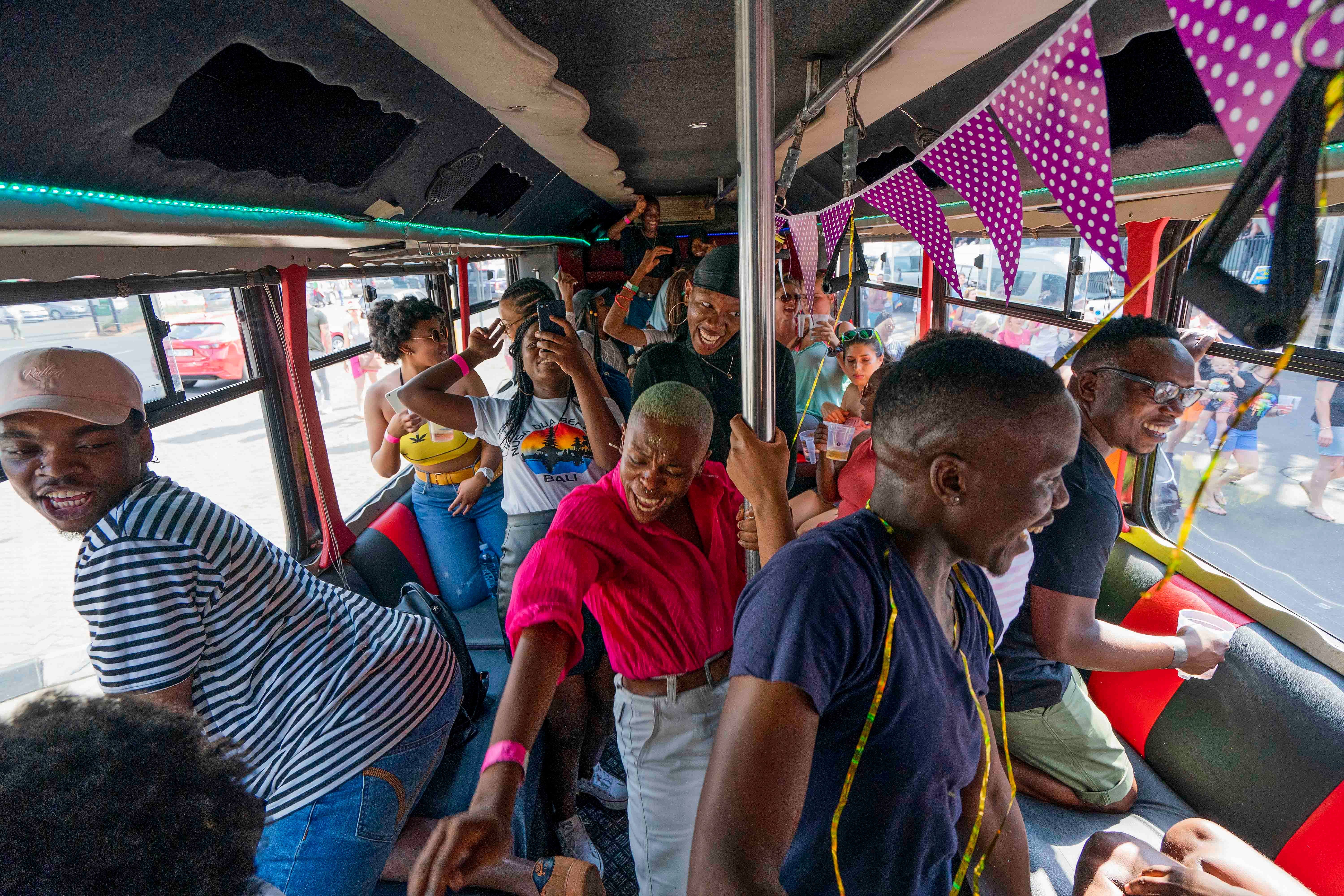 People on a bus among the thousands participating in the 30th Gay Pride event in Johannesburg, South Africa, October 26, 2019. ©2019 AP Photo/Jerome Delay