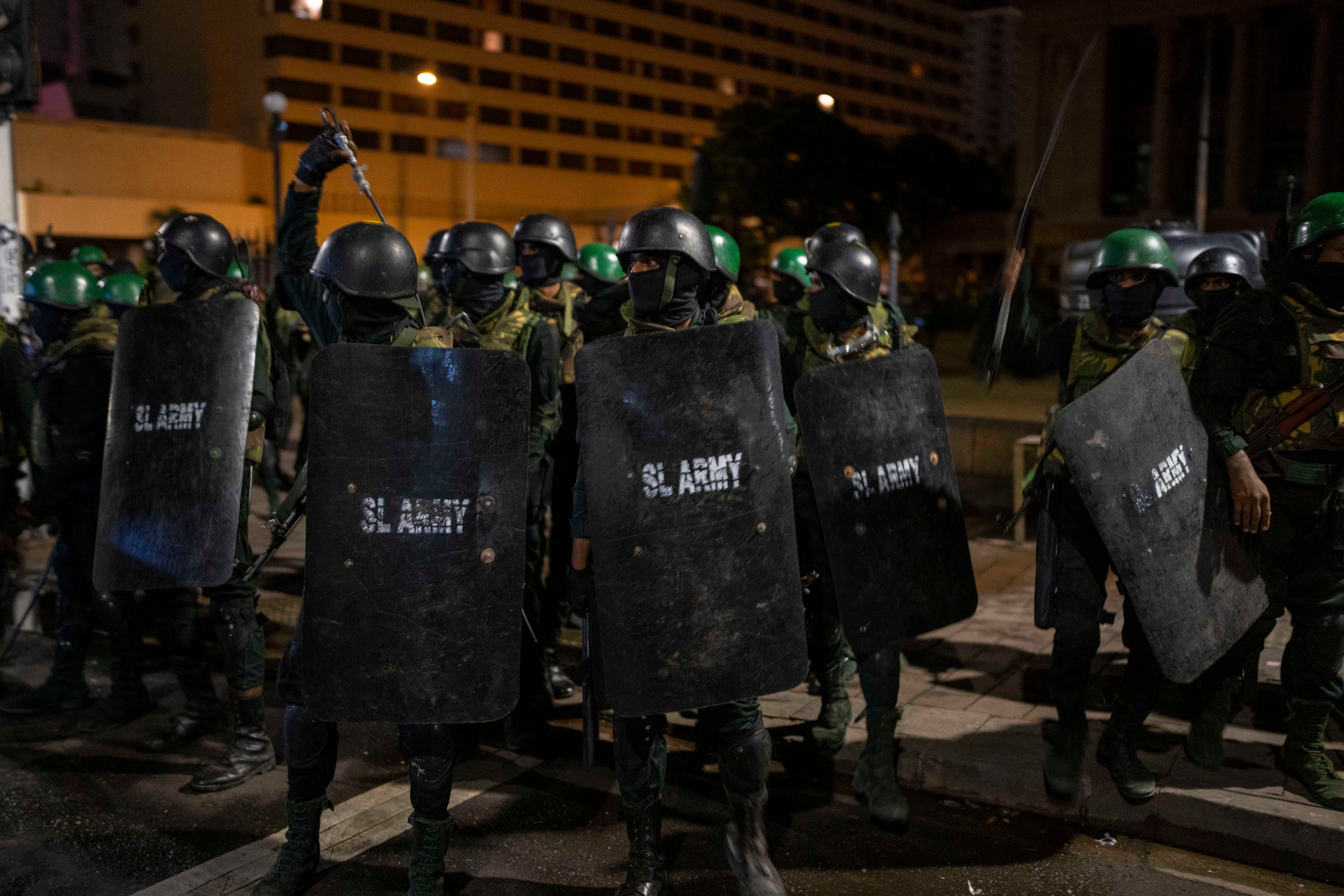 Sri Lankan army soldiers prepare to remove protesters and their tents from the site of a protest camp in Colombo, Sri Lanka, July 22, 2022.