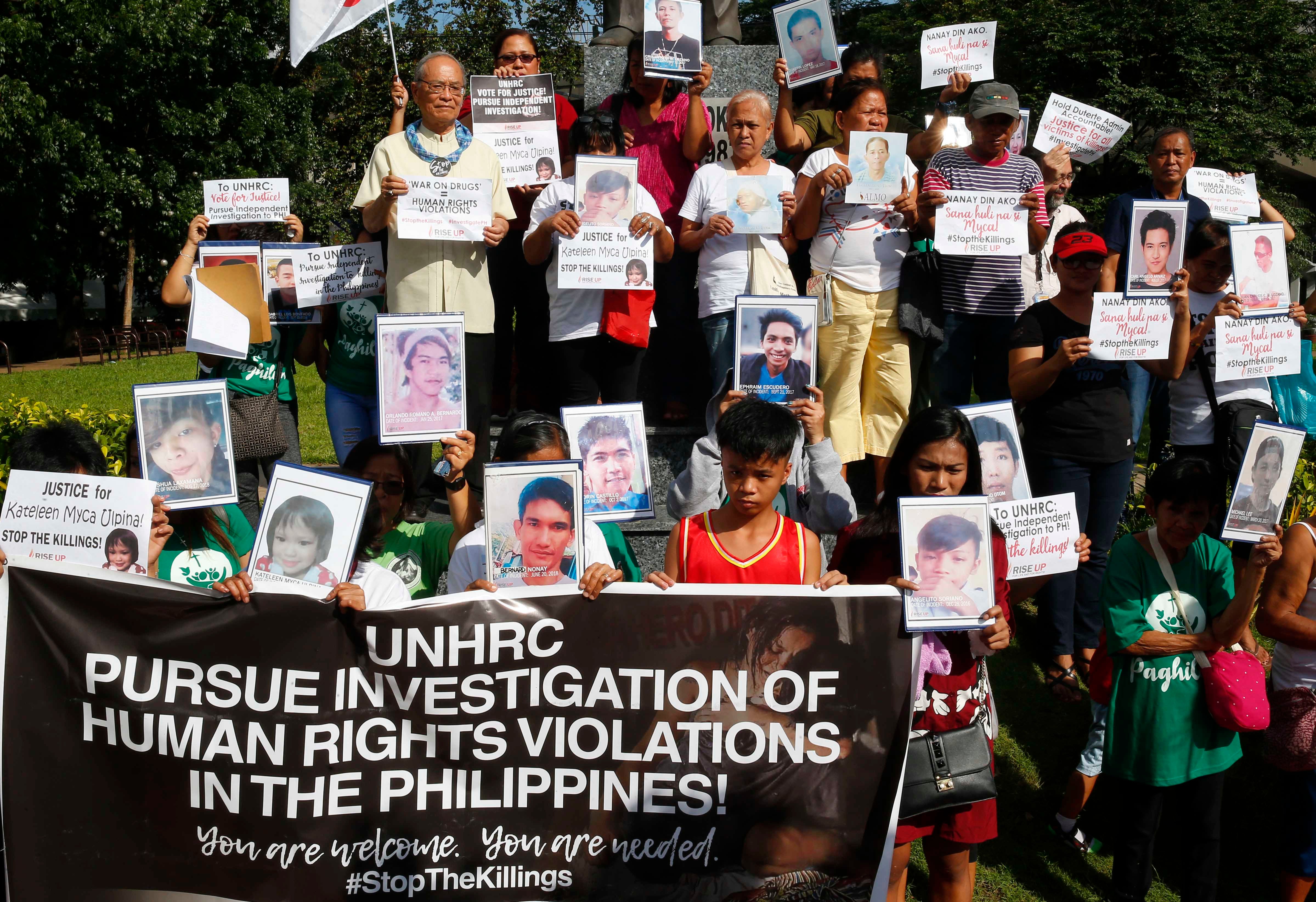 Families of victims of extrajudicial killings in the "war on drugs" display portraits of their slain relatives and call on the UN Human Rights Council to investigate the killings, in Quezon City, Philippines, July 9, 2019.