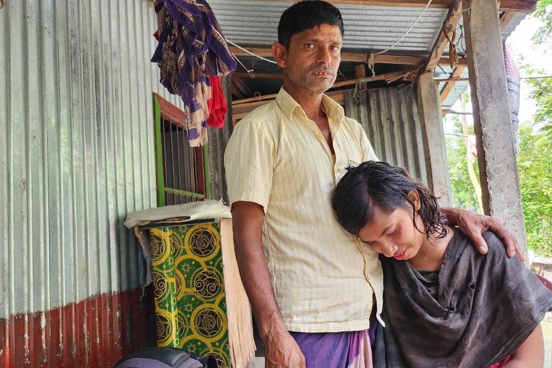 A man stands next to his daughter