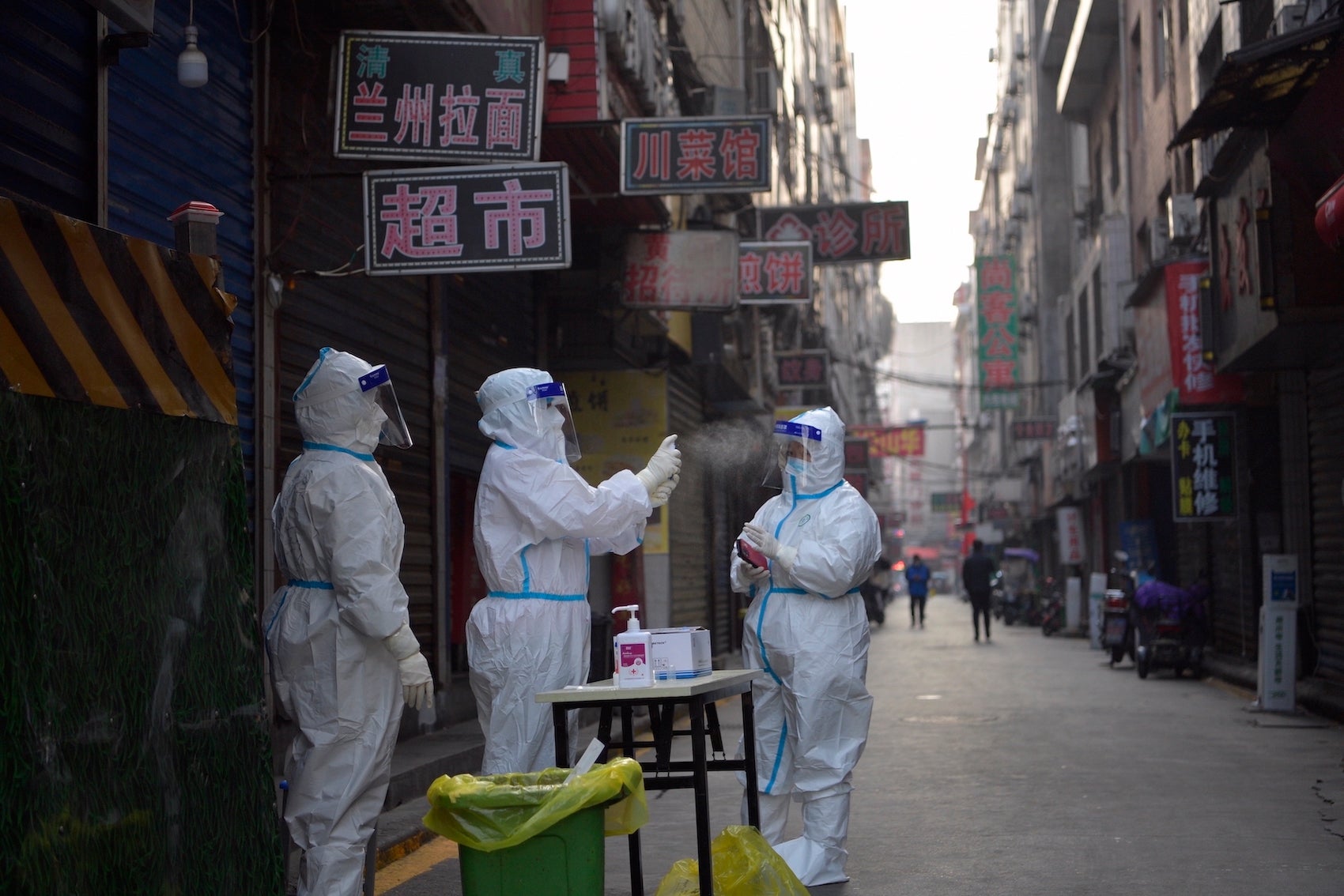 A medical worker disinfects her colleague's protective shield at a residential community under closed-off management in Xi'an, China.