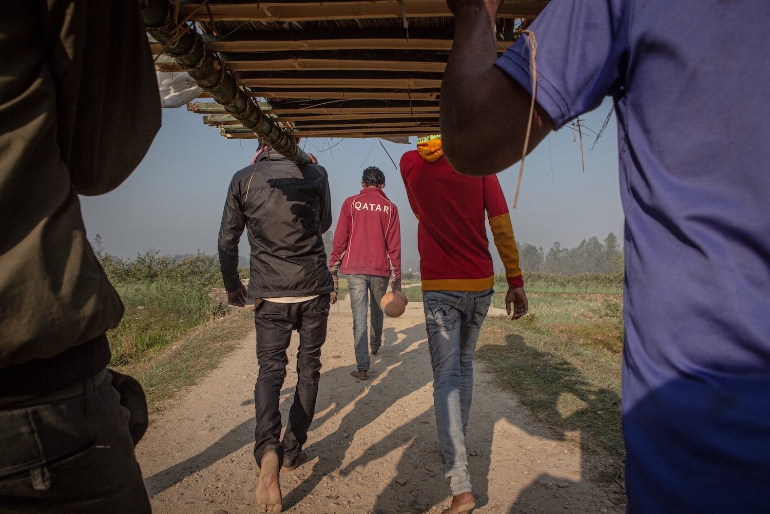 Family members cremate the body of Kripal Mandal, a Nepali laborer who died at age 39 in Qatar.