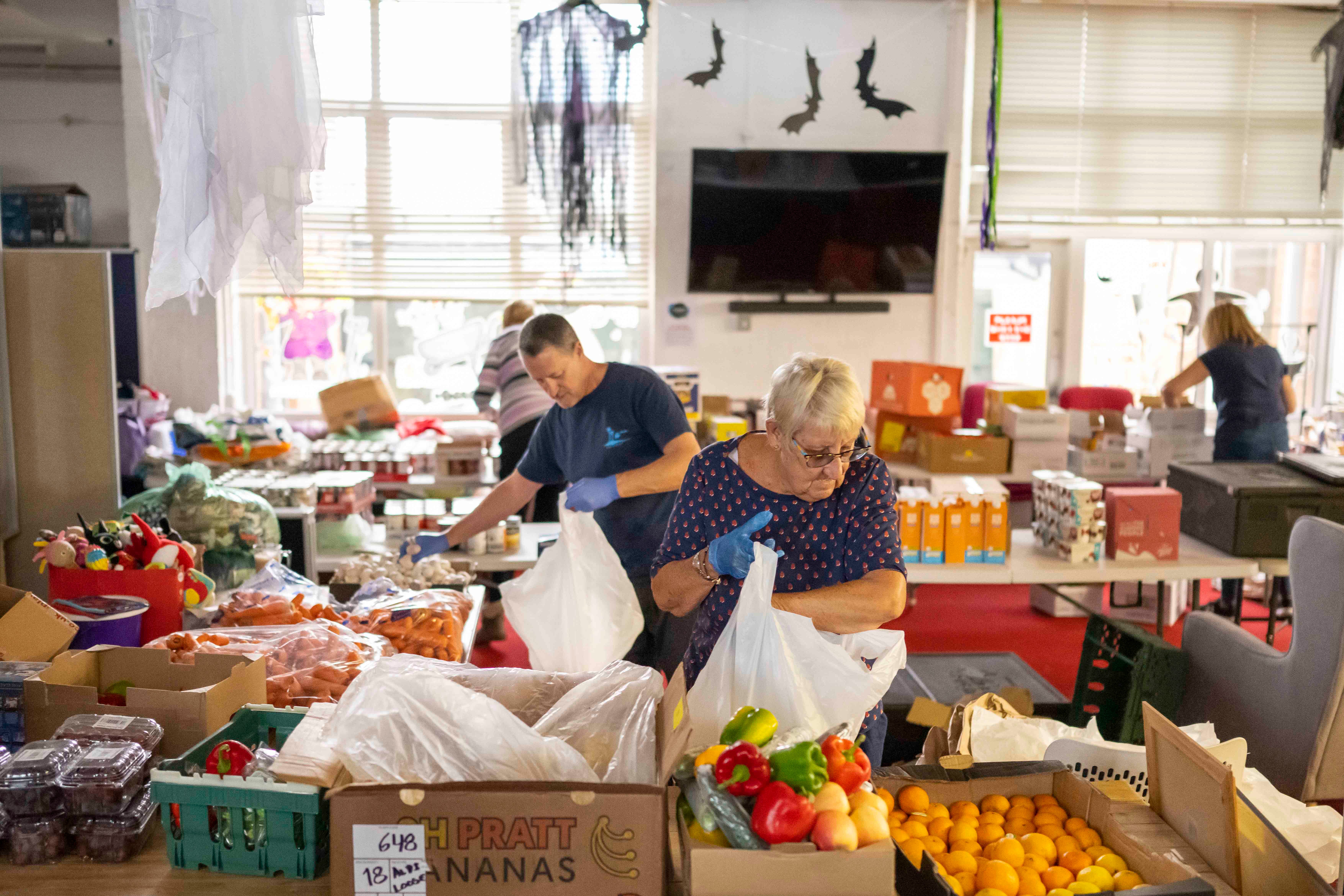 Volunteers sort food into food parcels at the Rumney Forum community charity on November 8, 2022 in Cardiff, Wales. 