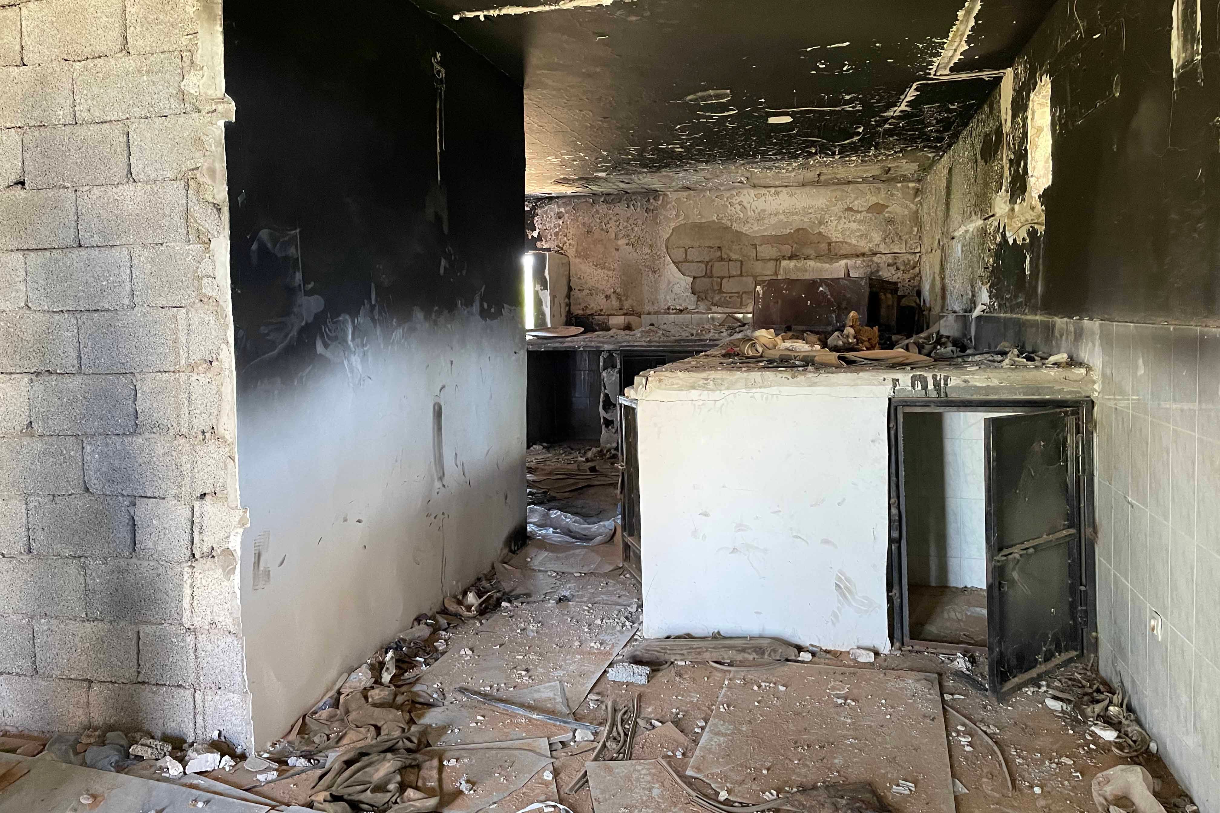 Abandoned and burnt cells at make-shift prison known as “Boxes Prison” in Tarhouna, used to detain, ill-treat, and disappear detainees during 2019-2020 conflict.