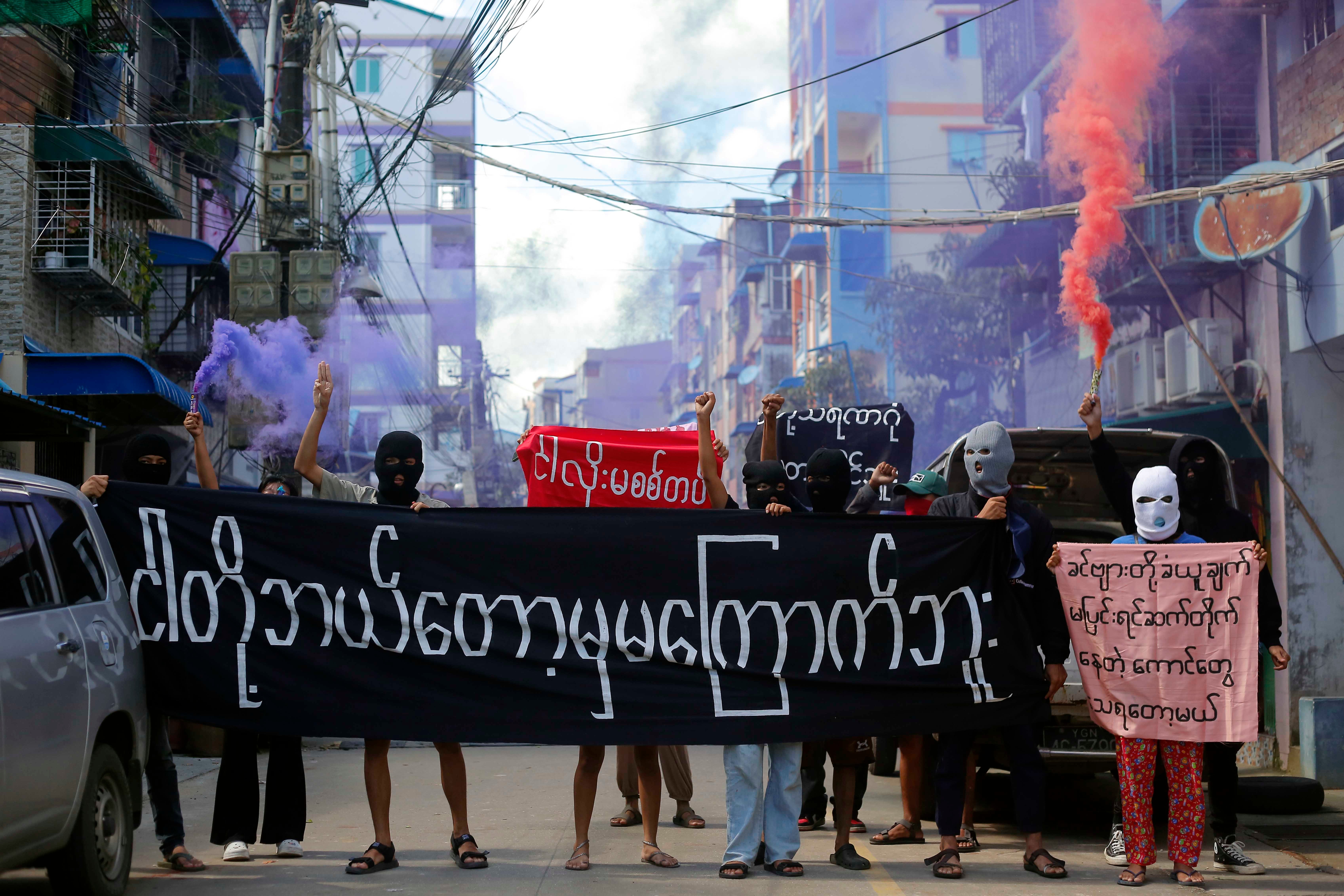 Protesters hold a banner reading “We will never be frightened,” in Yangon, Myanmar