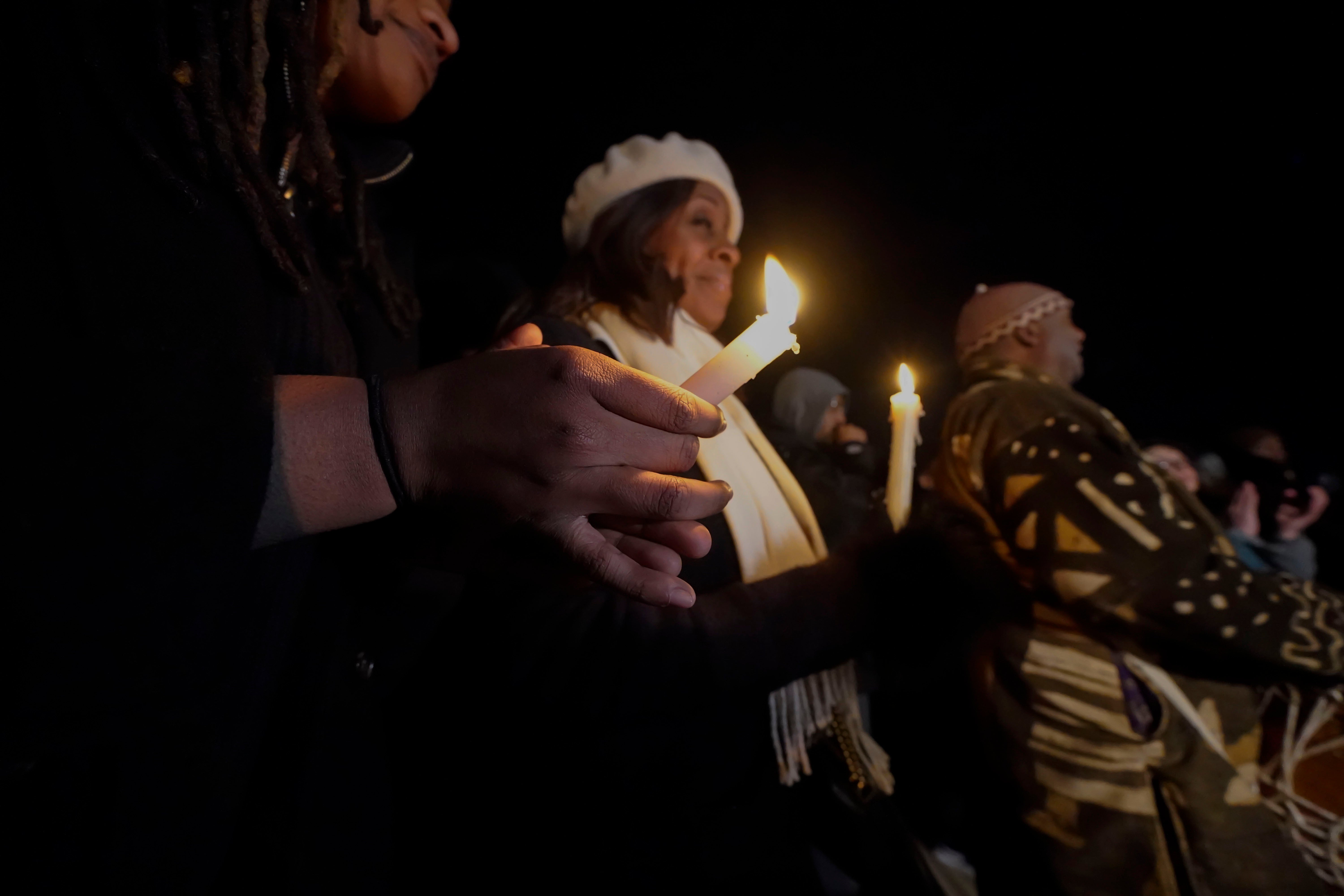 People hold candles at a vigil for Tyre Nichols in Memphis, Tennessee