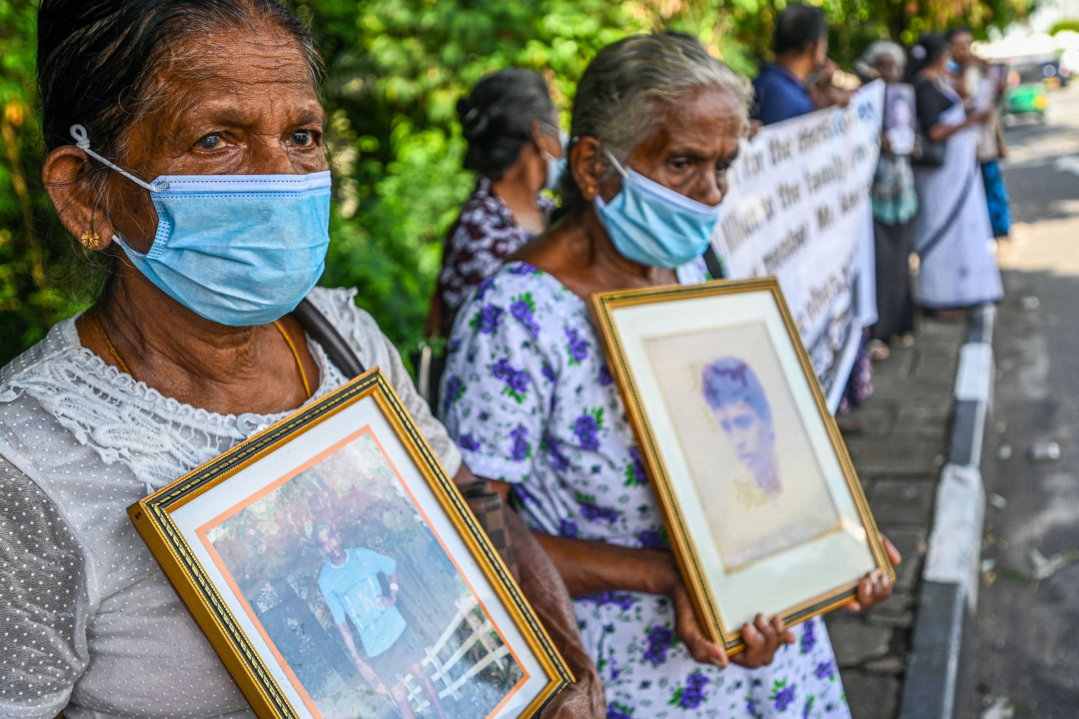 Women hold portraits of family members who went missing during Sri Lanka’s civil war that ended in 2009, during a demonstration in Colombo.