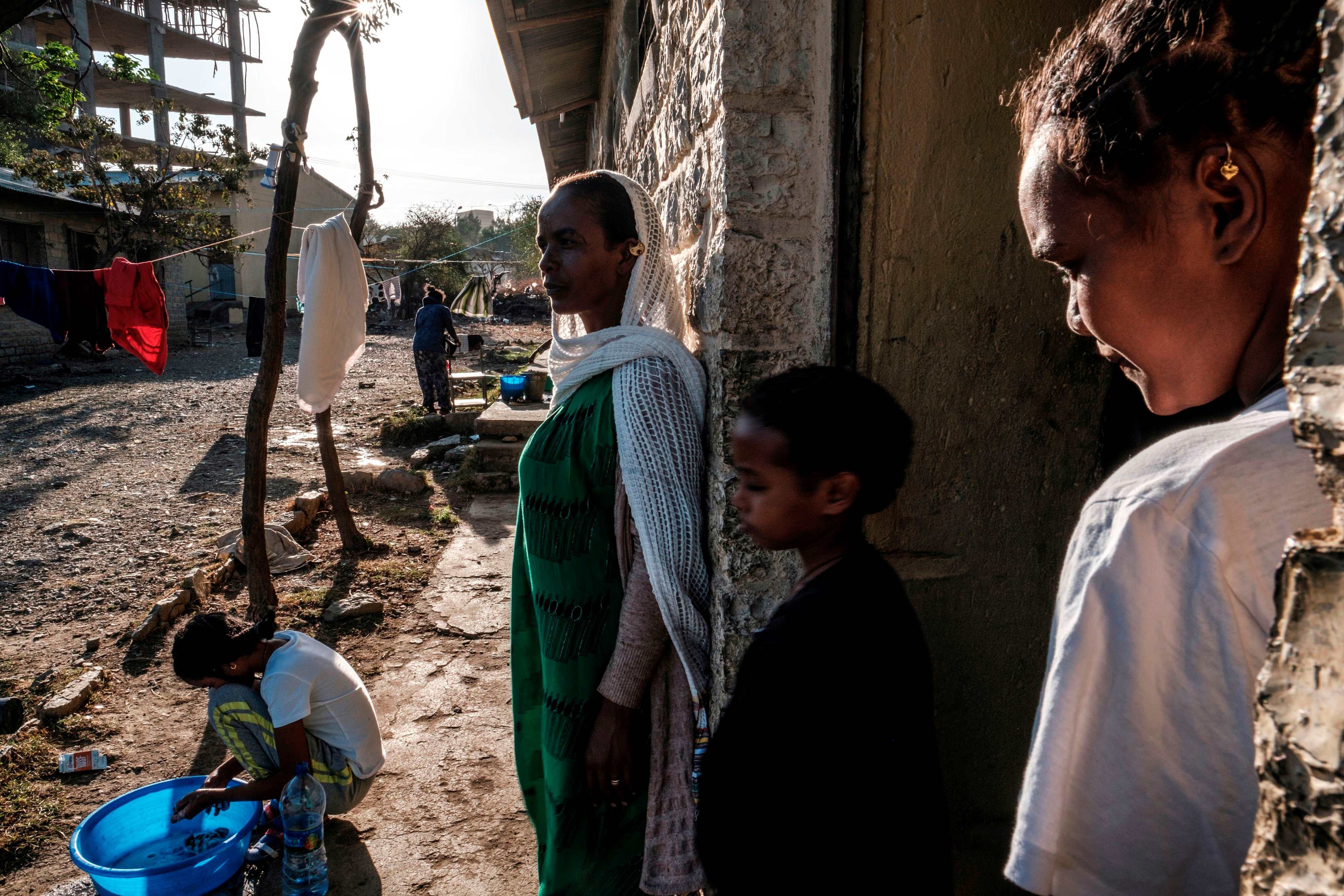 Displaced people from Western Tigray stand outside a school where they are sheltering in Mekele, Ethiopia, February 24, 2021. 
