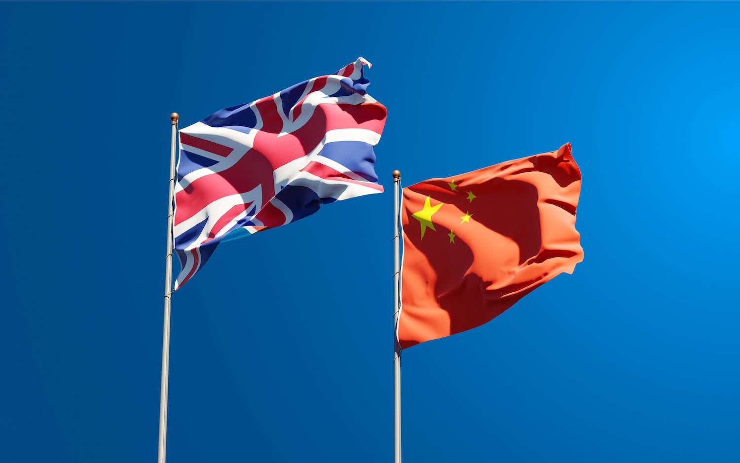 The national flags of the United Kingdom and China together.