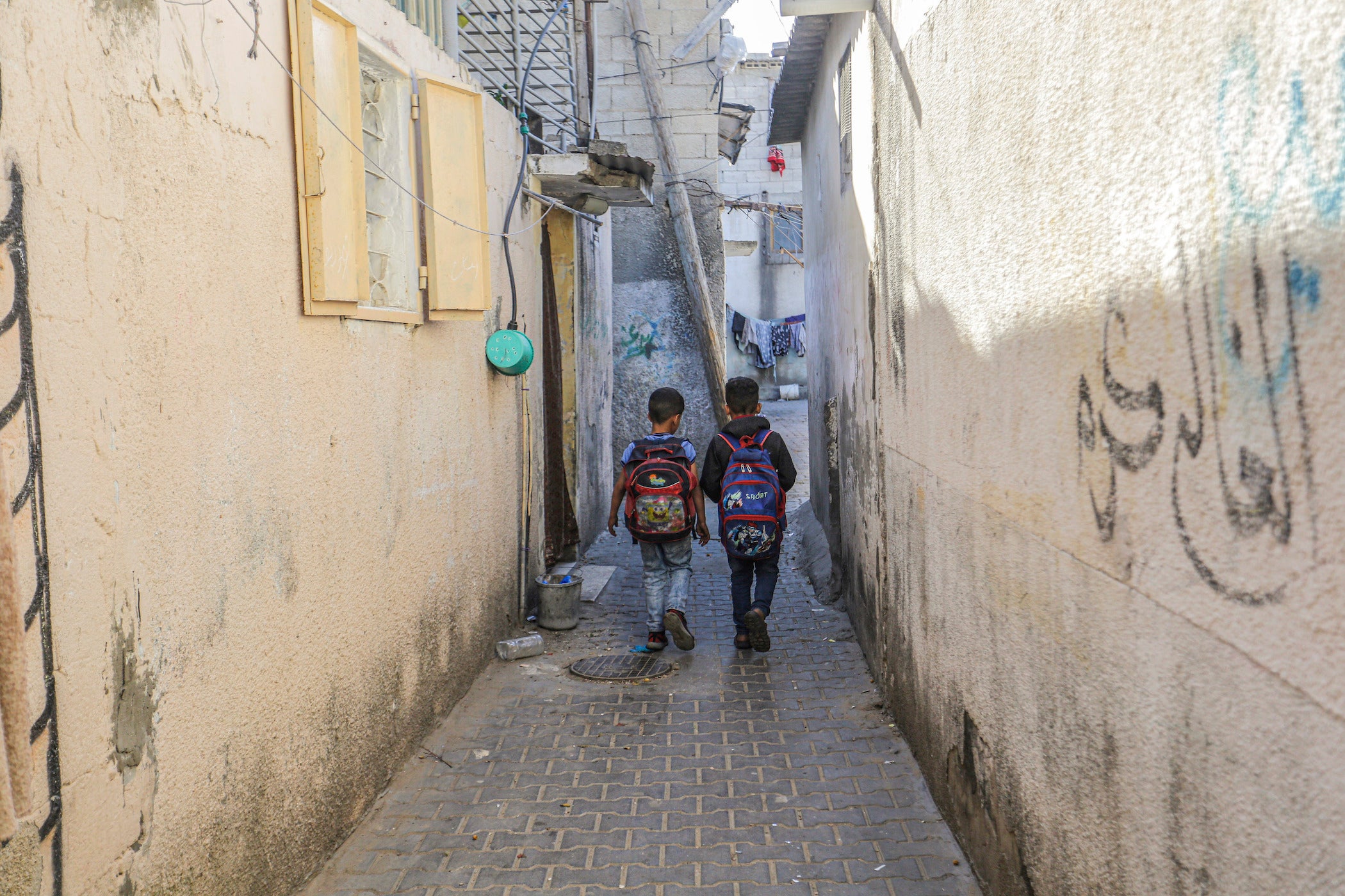 Palestinian children return from school to their homes in the Jabalia Refugee Camp on the 74th Anniversary of Nakba Day in the northern Gaza Strip.