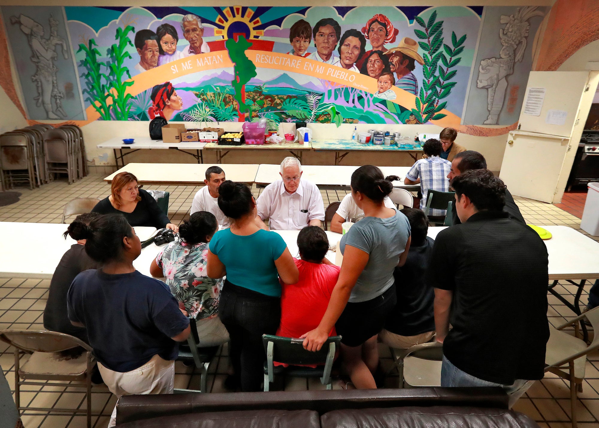  Ruben Garcia, director of the Annunciation House, speaks with migrant parents, El Paso, Texas.