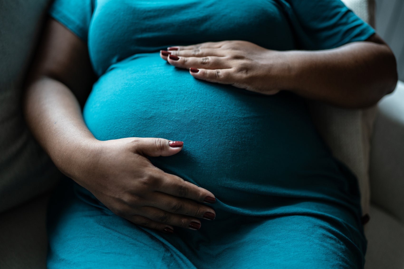  Pregnant woman touching her belly. 