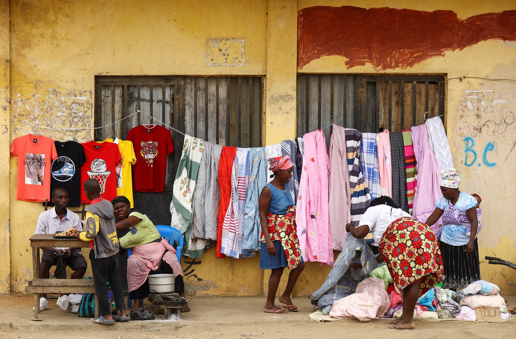 Street vendors serve customers in Luanda, Angola, August 20, 2022. 