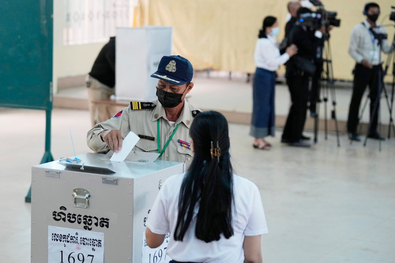 A police officer drops his ballot at a polling station in Takhmau in Kandal province, southeast of Phnom Penh, Cambodia, June 5, 2022.