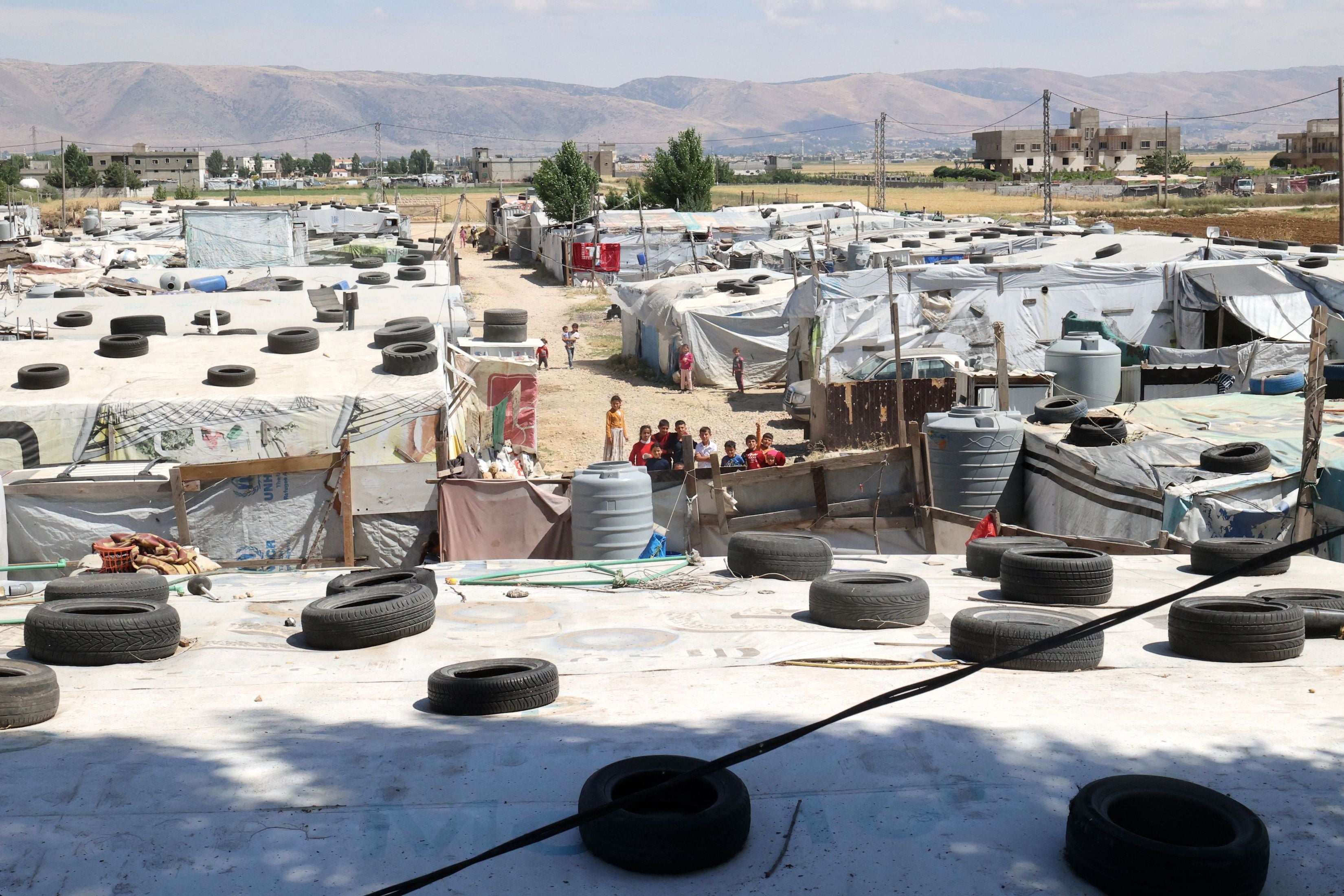 Syrian children gather between tents at a refugee camp in Saadnayel in eastern Lebanon's Bekaa Valley, June 13, 2023.