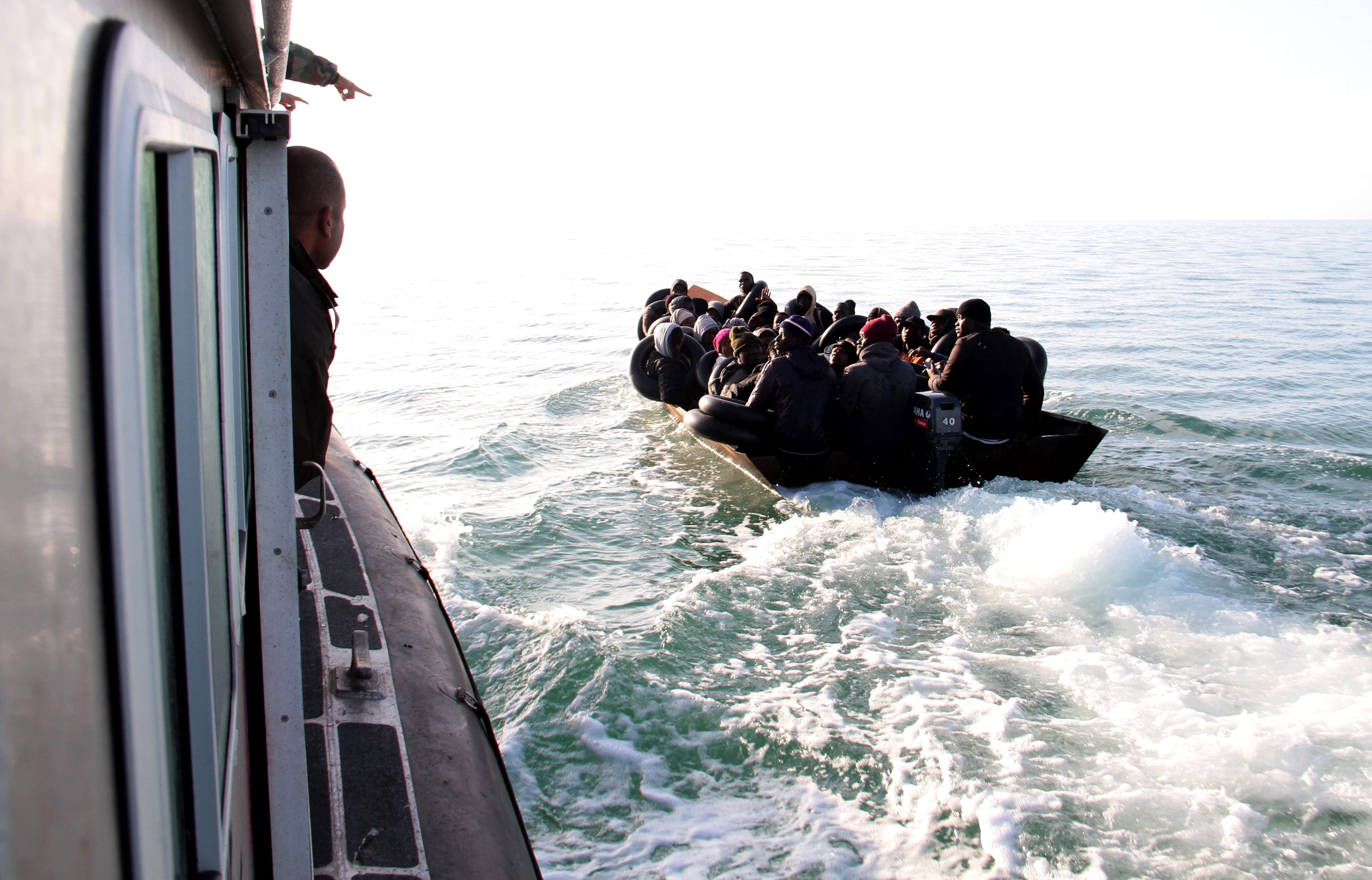 The Tunisian Maritime National Guard (coast guard) approaches a boat at sea carrying people from different African countries seeking to get to Italy, near the coast of Sfax, Tunisia, Tuesday, April 18, 2023. © 2023 AP Photo