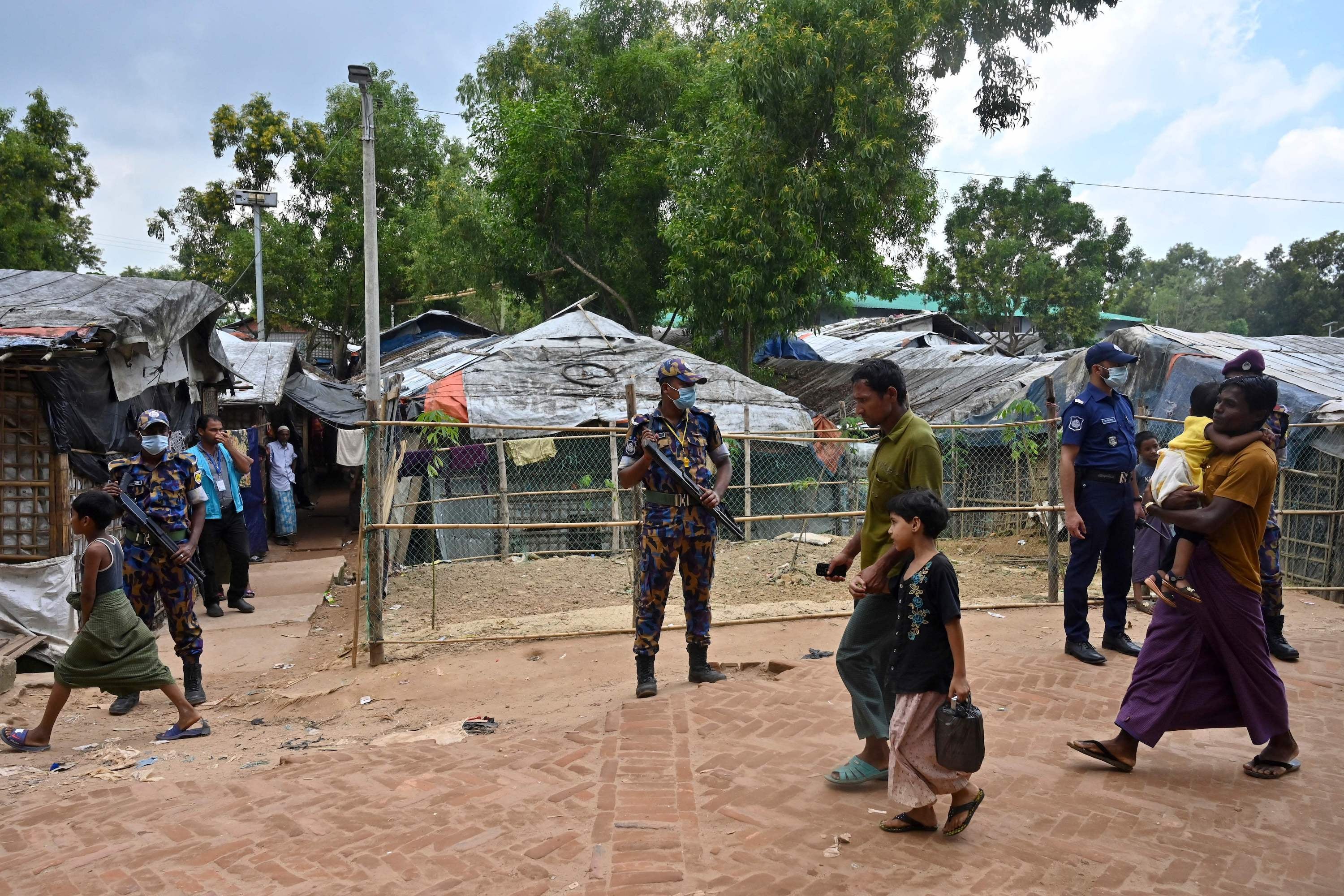 Security force officers stand guard after the killing of Rohingya community leader Mohib Ullah in the Kutupalong refugee camp, Bangladesh, October 2021.