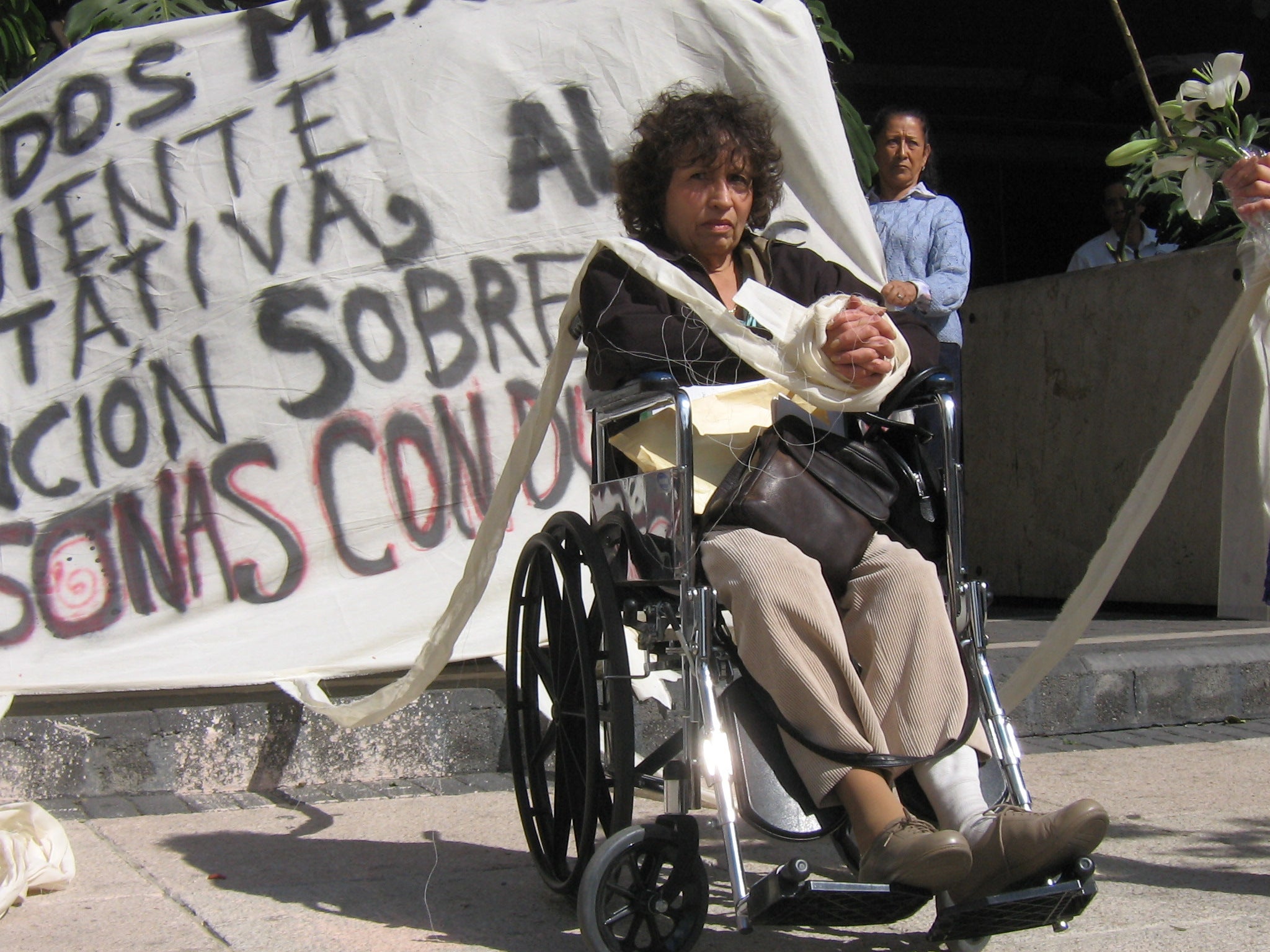 Marite Fernández represents a woman unable to move her hands because of guardianship laws in front of the Mexican Senate, Mexico City, Mexico, 2007. 