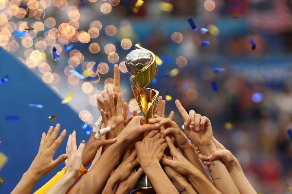 In this July 7, 2019, file photo, the United States players hold the trophy as they celebrate winning the Women’s World Cup final soccer match against The Netherlands at the Stade de Lyon in Decines, outside Lyon, France. The 2023 Women’s World Cup will be spread across nine cities in Australia and New Zealand. (AP Photo/Francisco Seco, File)