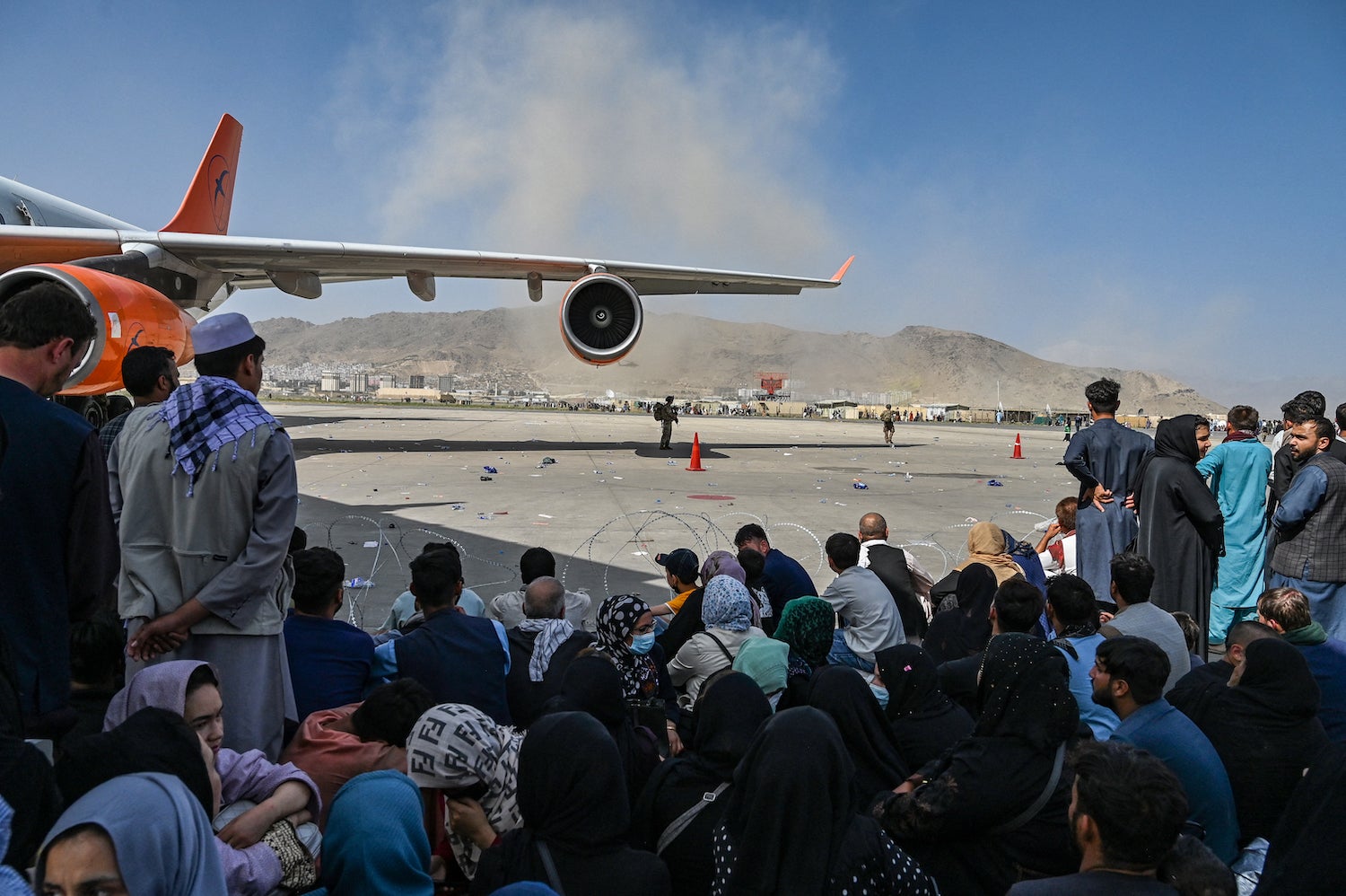 Afghans waiting to leave Afghanistan from Kabul’s international airport after the Taliban takeover, August 16, 2021.