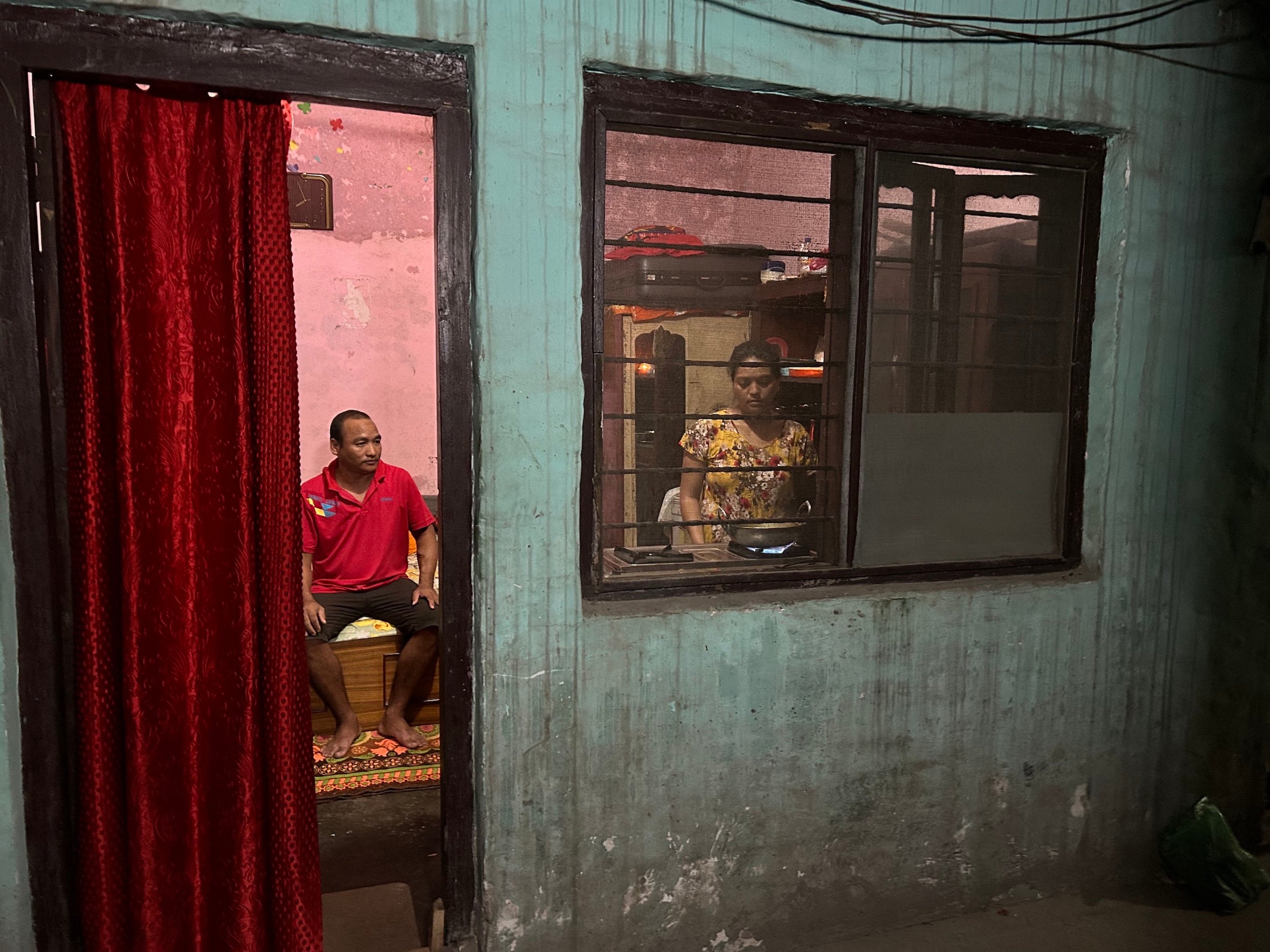 Purna’s wife, Kabita, preparing dinner the night before his dialysis while he assists, Butwal, Nepal, July 19, 2023.