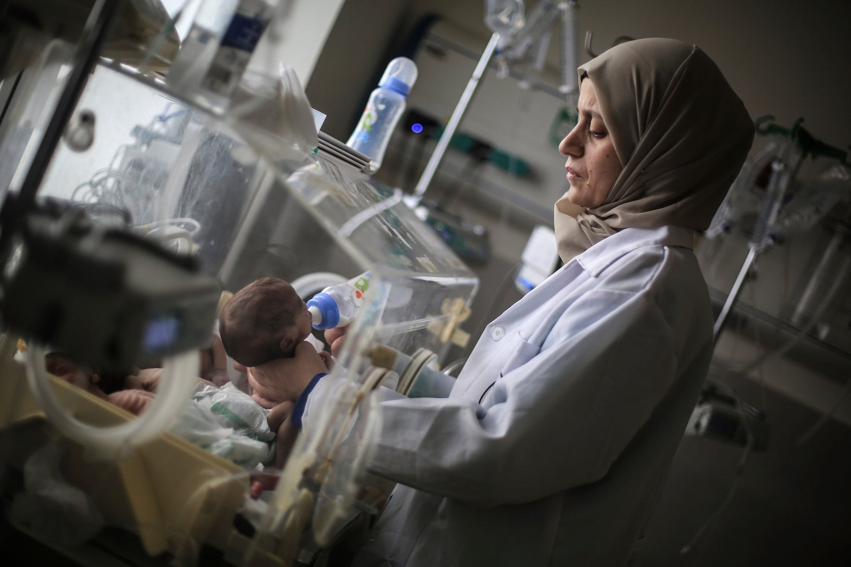 A Palestinian doctor in a hospital in Rafah in the southern Gaza Strip prepares a premature baby to be transferred to Egypt to receive proper medical care, November 20, 2023. 