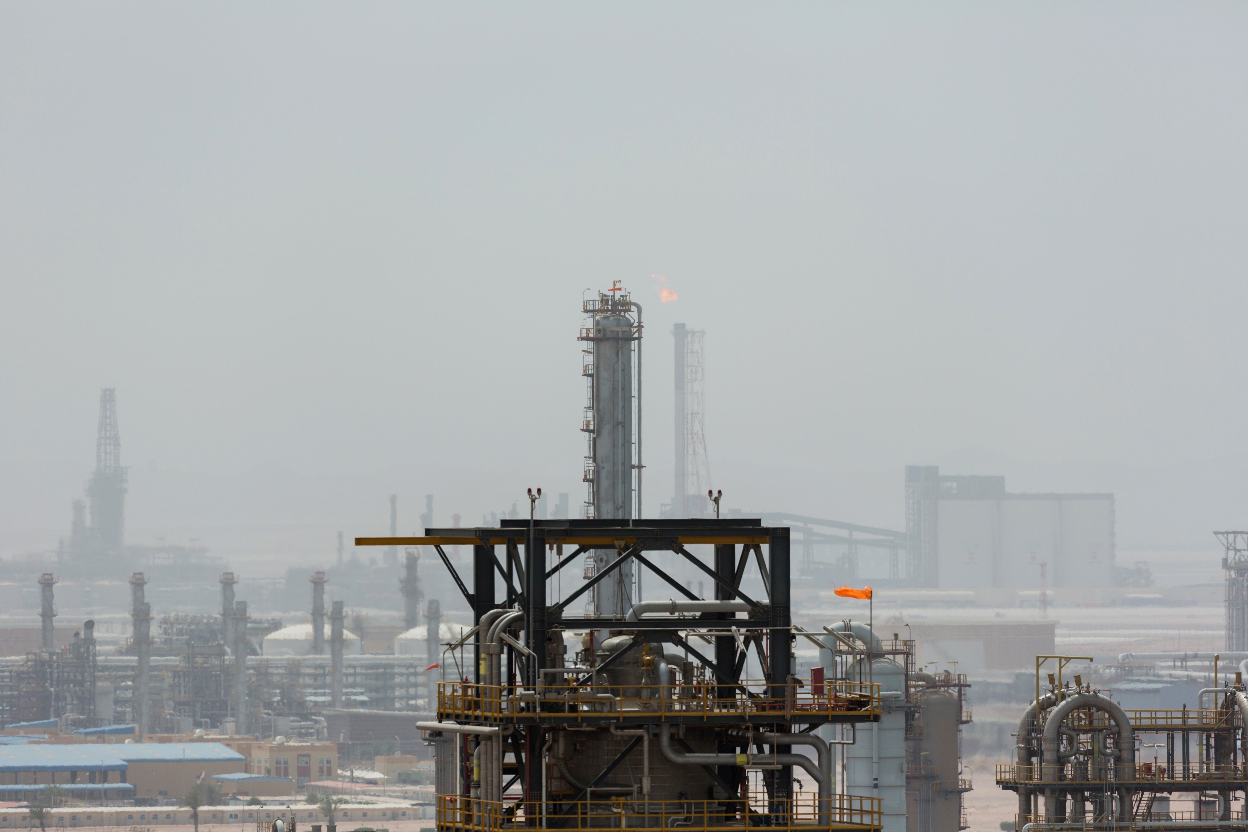 A flame burns waste gas in a refinery