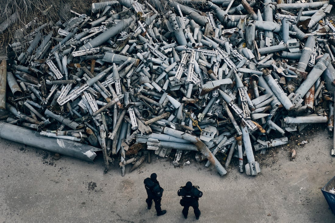Ukrainian police officers look at collected fragments of rockets, including cluster rounds, that hit Kharkiv, in Kharkiv, Ukraine, December 3, 2022. 