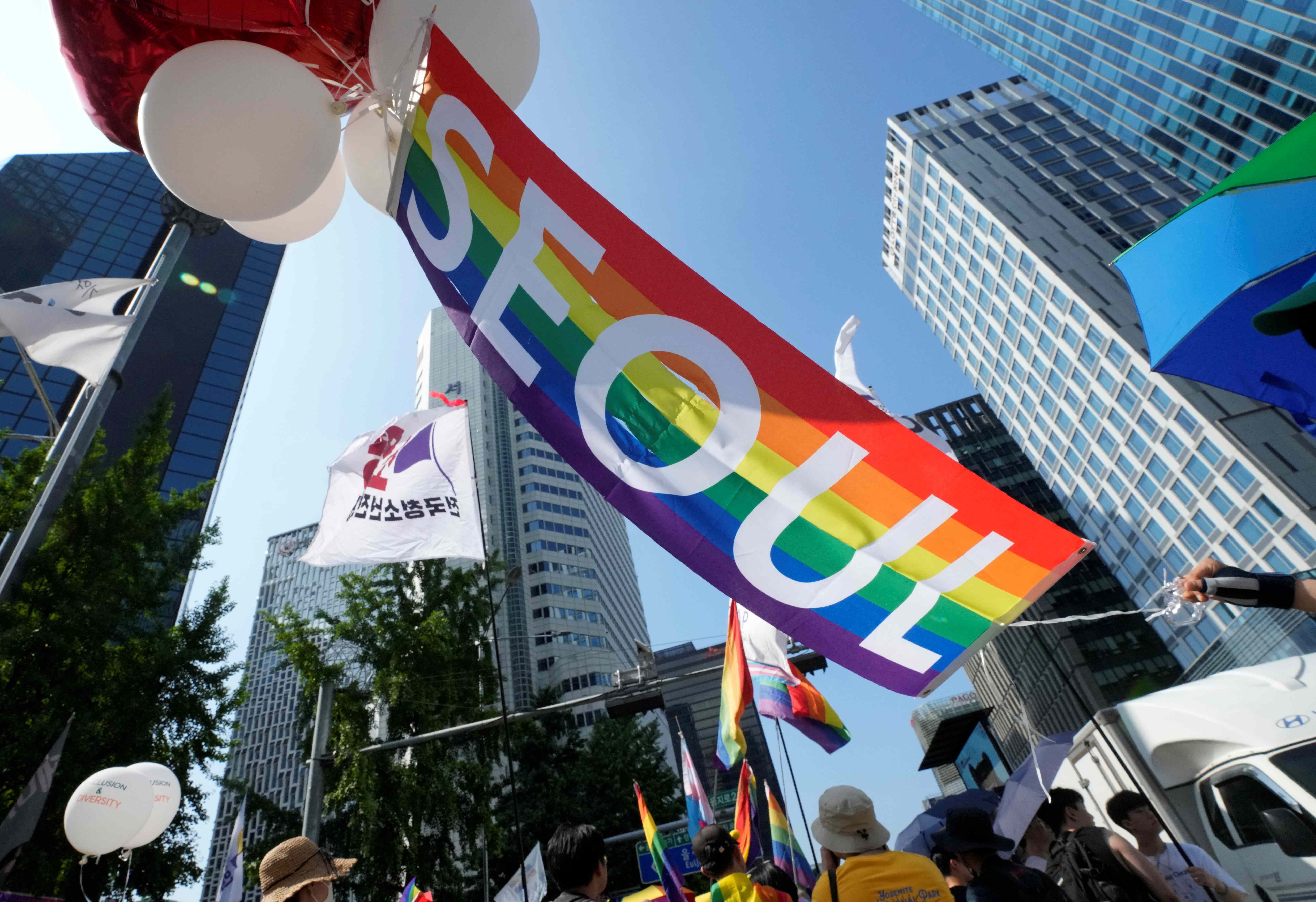 A rainbow banner is held aloft during the Seoul Queer Culture Festival in Seoul, South Korea, July 1, 2023.