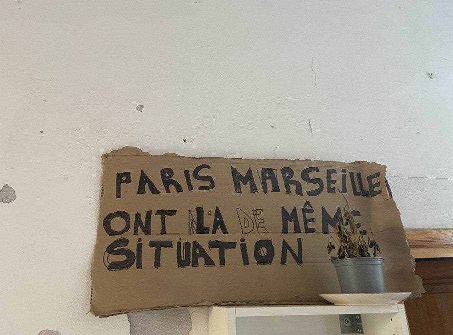 A sign at the Collectif 113 squat in Marseille reads “Paris, Marseille, we are in the same situation”