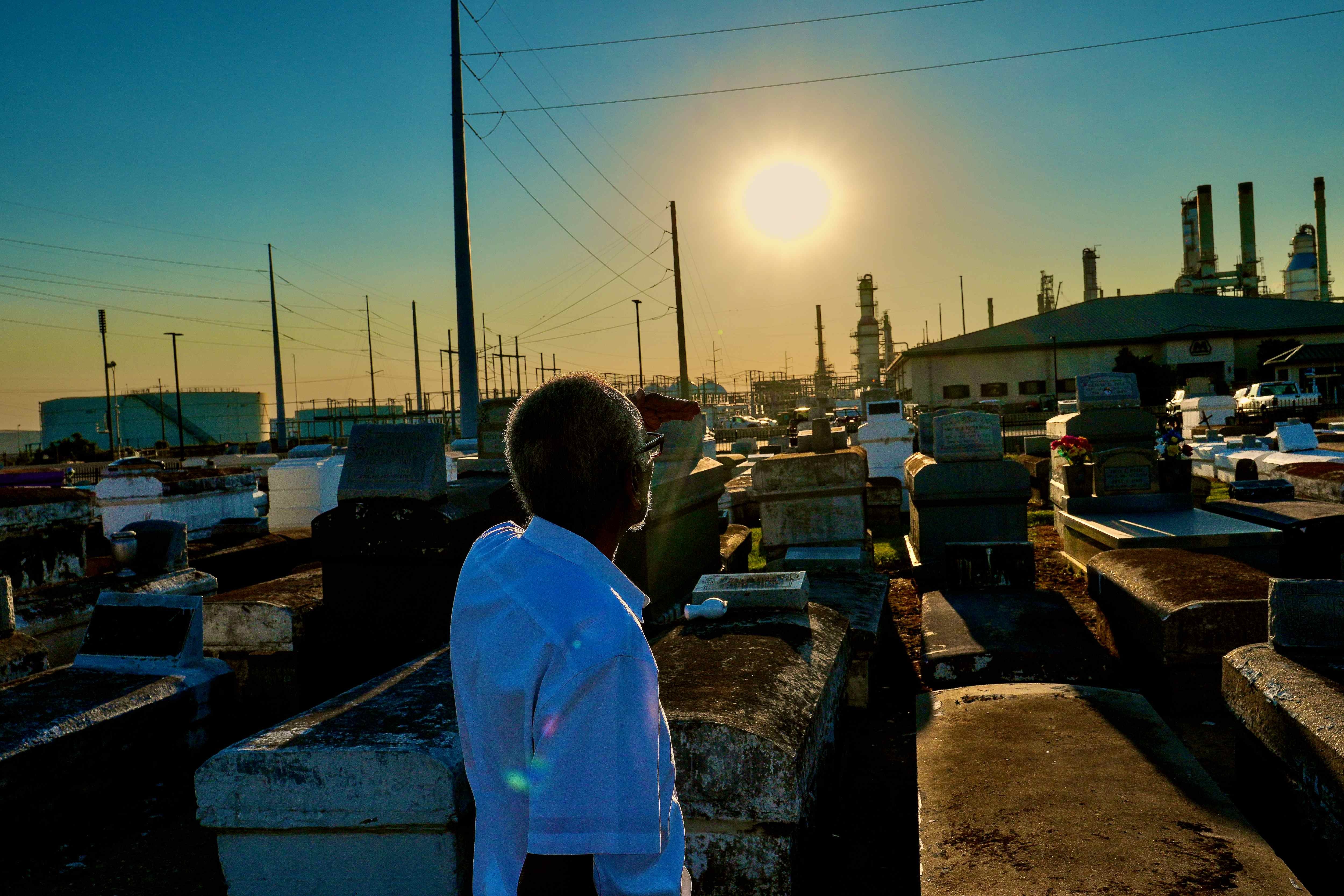 A man stands in a cemetery