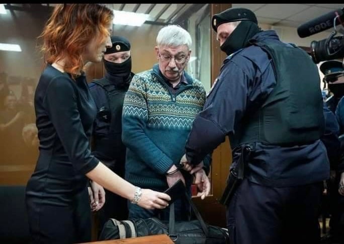 Human rights defender Oleg Orlov is handcuffed and taken into custody in the courtroom after being sentenced to two-and-a-half-years in prison, in Moscow, Russia, February 27, 2024.