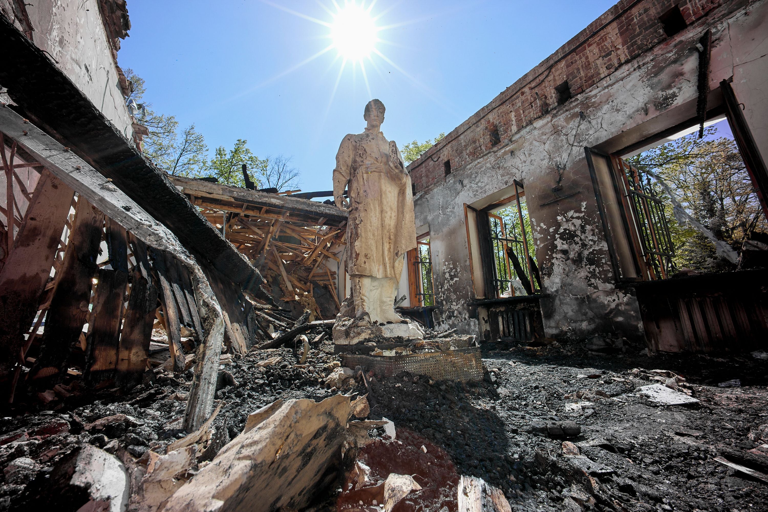 A statue stands amidst the ruins of a museum 