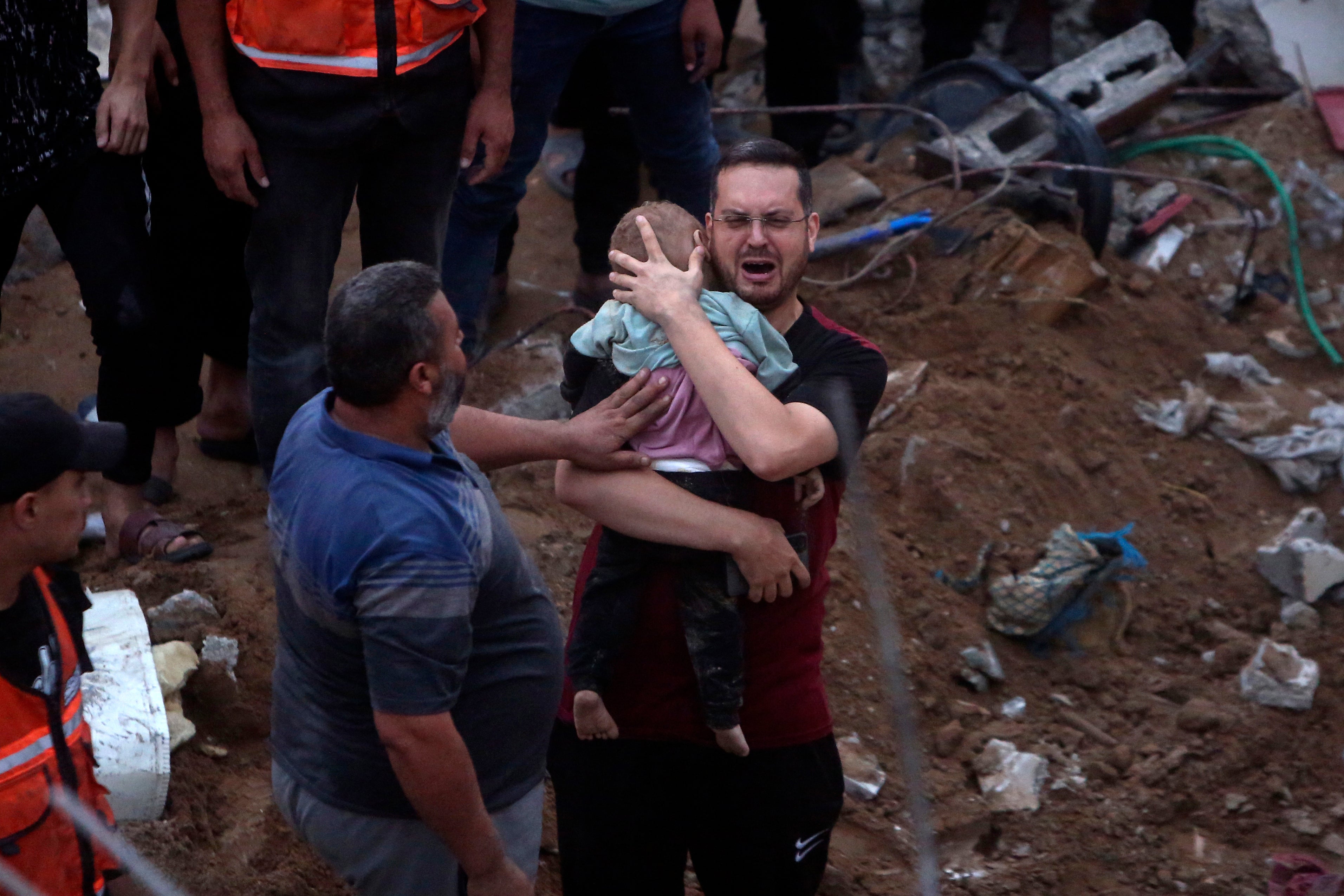 In the rubble of the Engineers’ Building, Karam al-Sharif, an UNRWA employee, holds one of his 18-month-old twin boys killed in the October 31 Israeli airstrike on the building that killed at least 106 civilians, including 5 of his children and 5 other relatives.