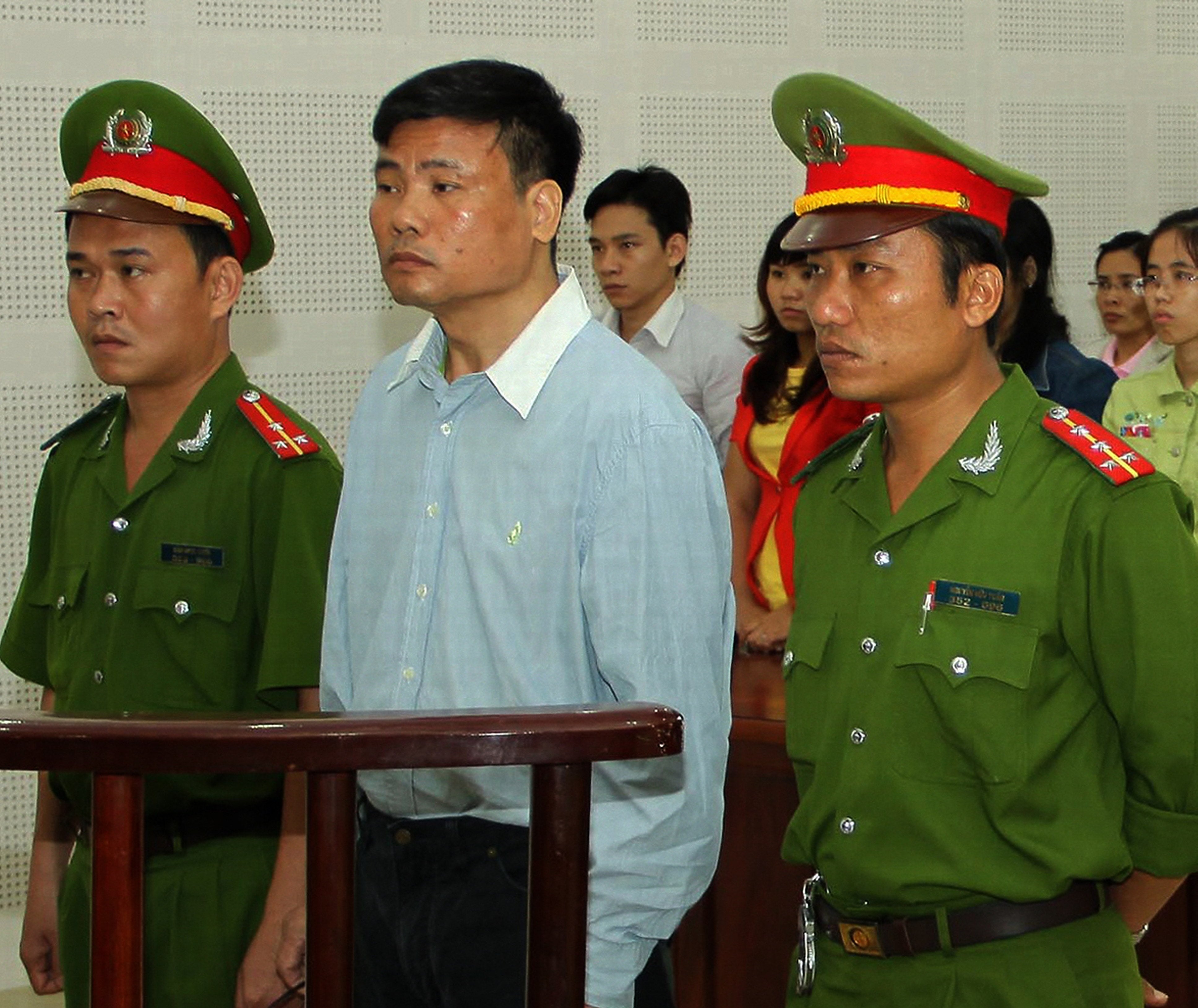 Blogger Truong Duy Nhat stands trial at a local People's Court in the central city of Da Nang, Vietnam, March 4, 2014.