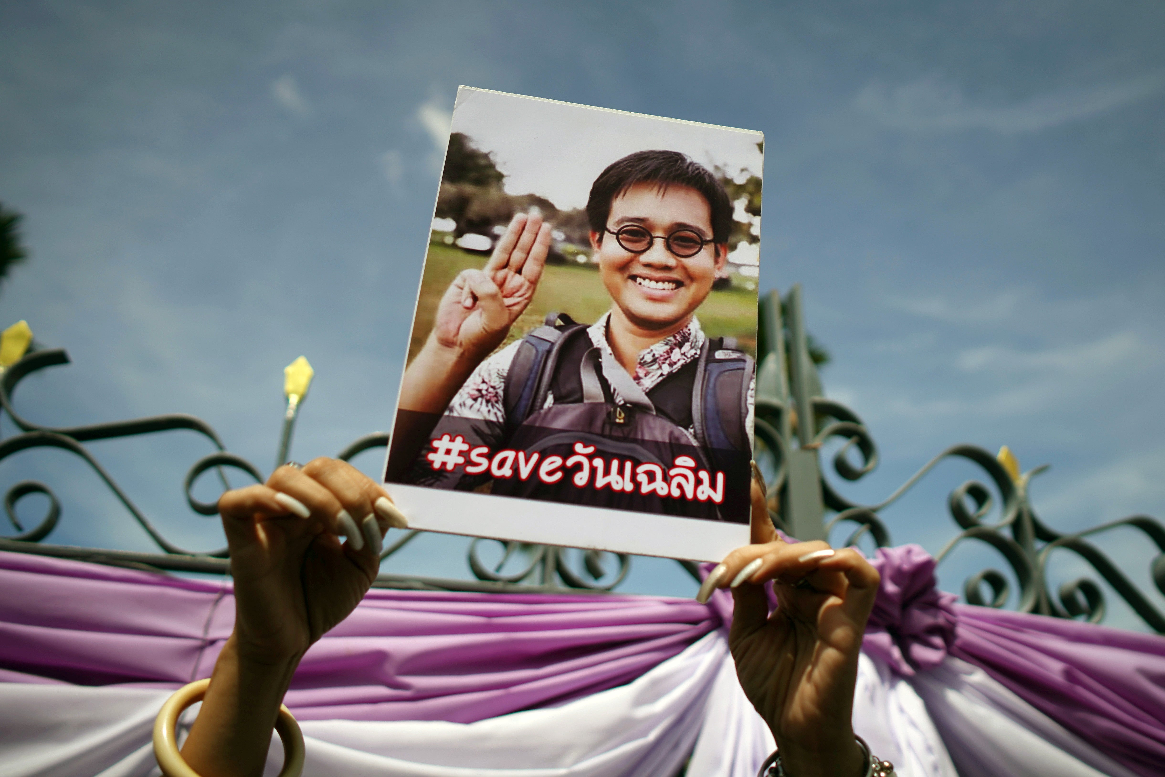 A photo of Thai activist Wanchalearm Satsaksit being held up as people gather in support of him during a protest calling for an investigation, in front of Government House in Bangkok, Thailand, June 12, 2020.