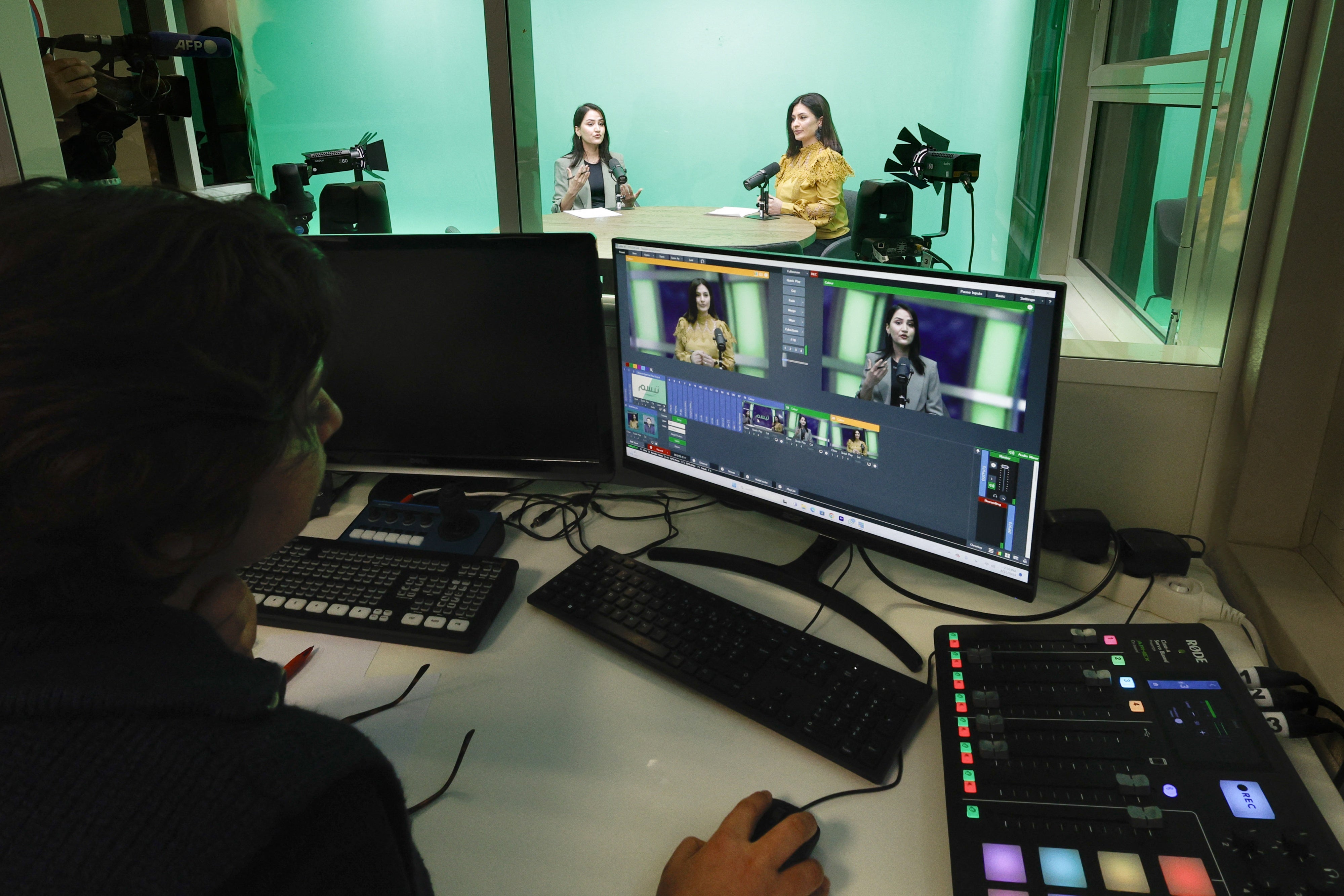 Women journalists being filmed in a tv news studio